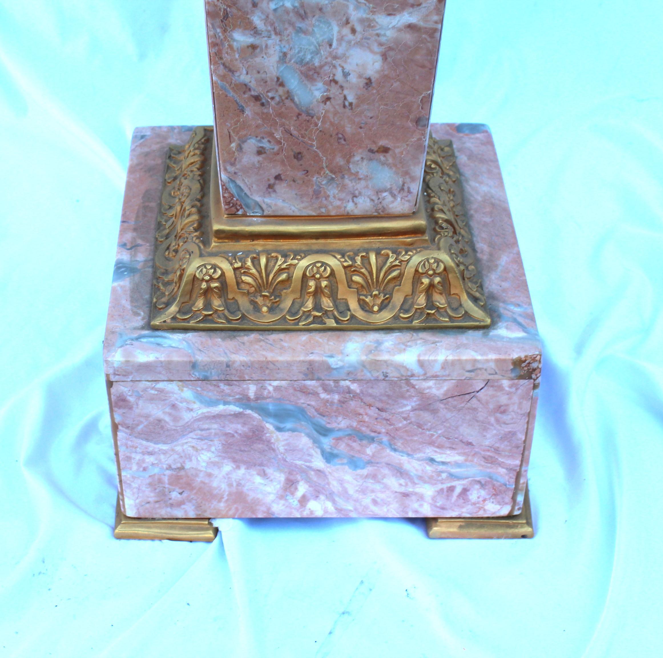 A custom made Pink Marble pedestal with Bronze mounts and hardware . All metal pieces ate hi lighted Gold plating. Known as  Lady Face pedestal . Top plate 13X13 is removable for shipping . This is a bit heavy and will require special handling and