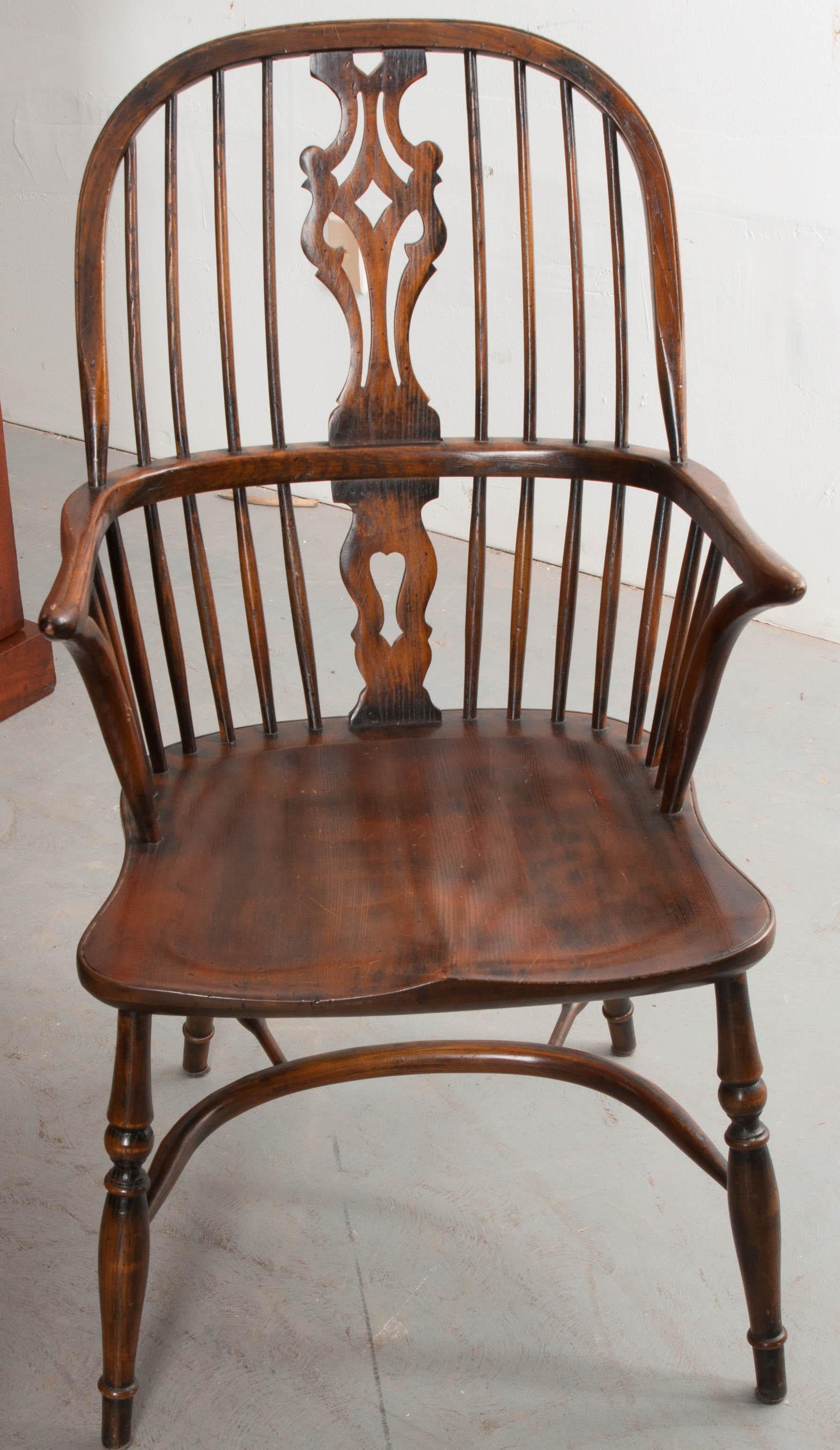 This fine set of Windsor style dining chairs was made in the traditional English style using beautifully toned oak. The chairs were made in the 1950s as reproductions, and have acquired a patina of their own over the past sixty-plus years. The