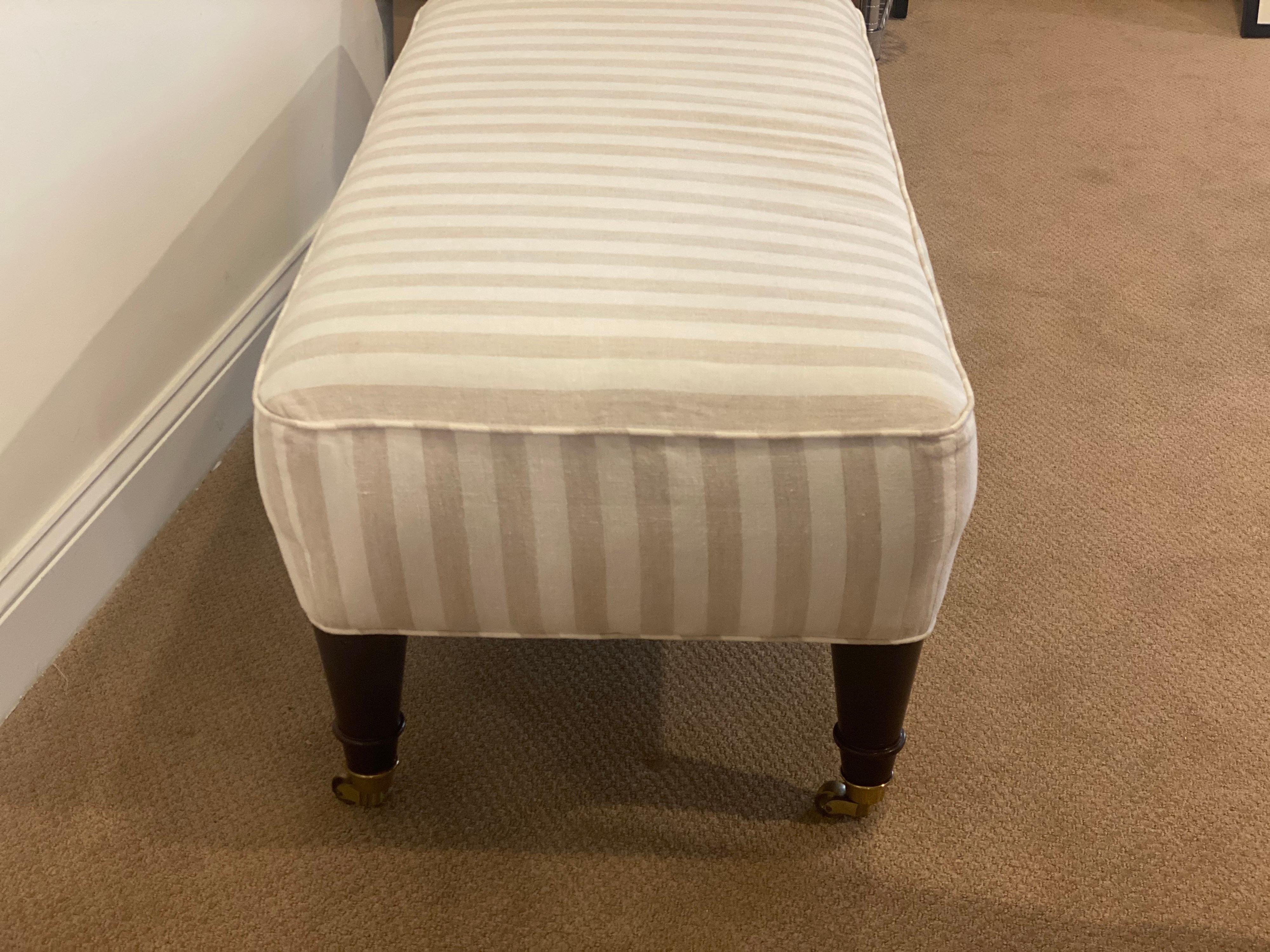 Classic turned taped legs on brass casters with a beige and white stripe fabric. This bench is in great condition, ready to use with only general expected wear to legs.
Measures: 44.25” wide x 21” deep x 17” high.