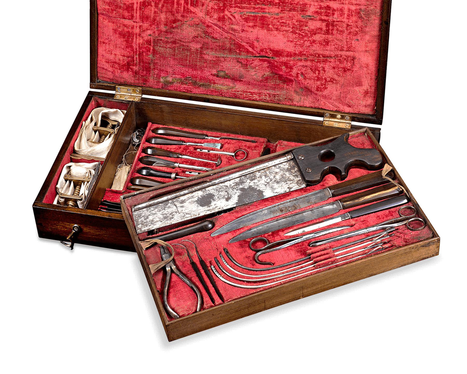 This exceptionally rare English surgeon's kit by Stodart of London was once used by a surgeon to perform amputations. Held in its original fitted case, the assemblage of ebony-handled instruments includes a large amputation saw, metacarpal saw,