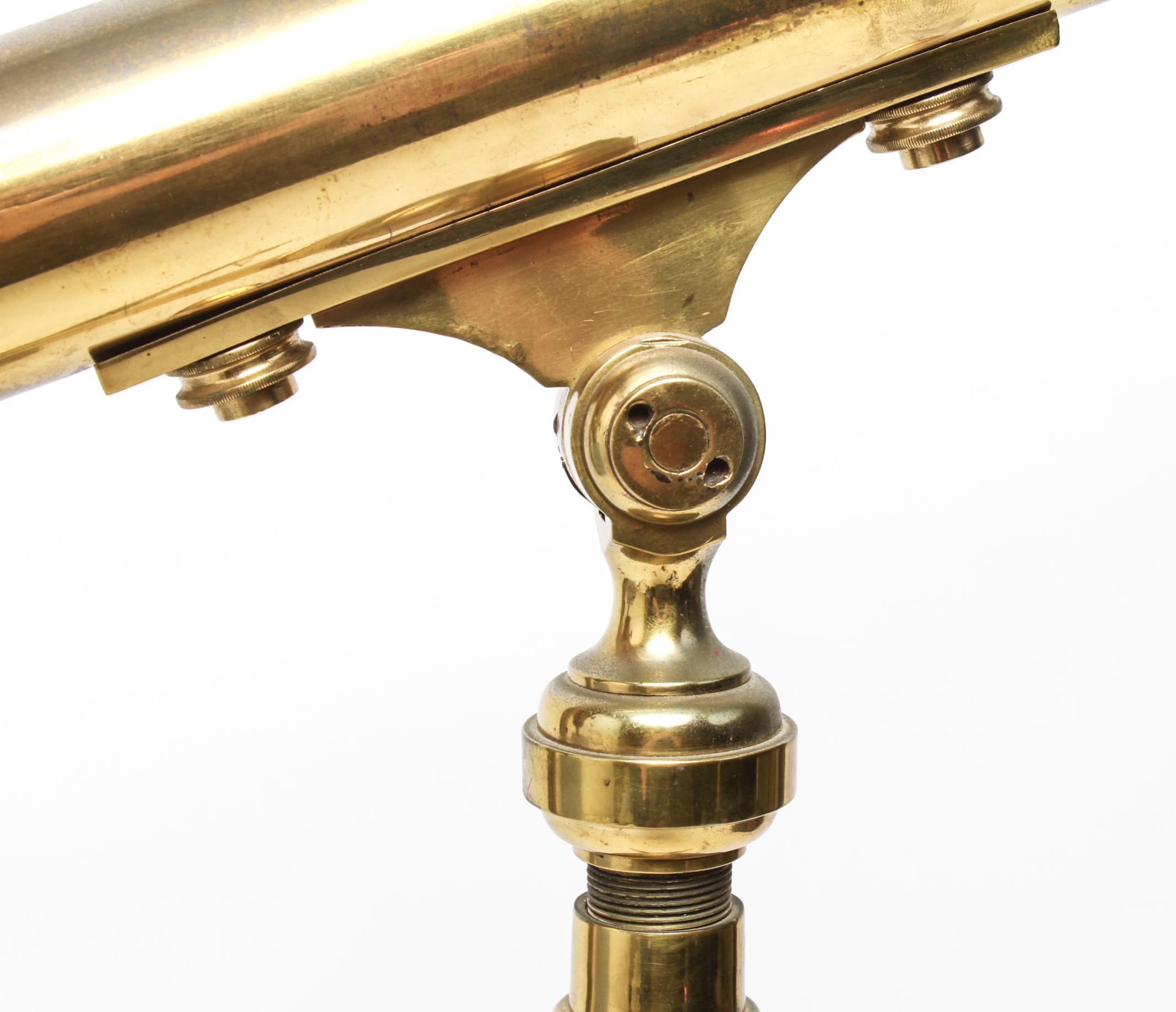 English tabletop telescope with adjustable height in solid brass, with a screw lock and standing atop folding tripod legs. The piece has some wear to the brass surfaces but is in great vintage condition.