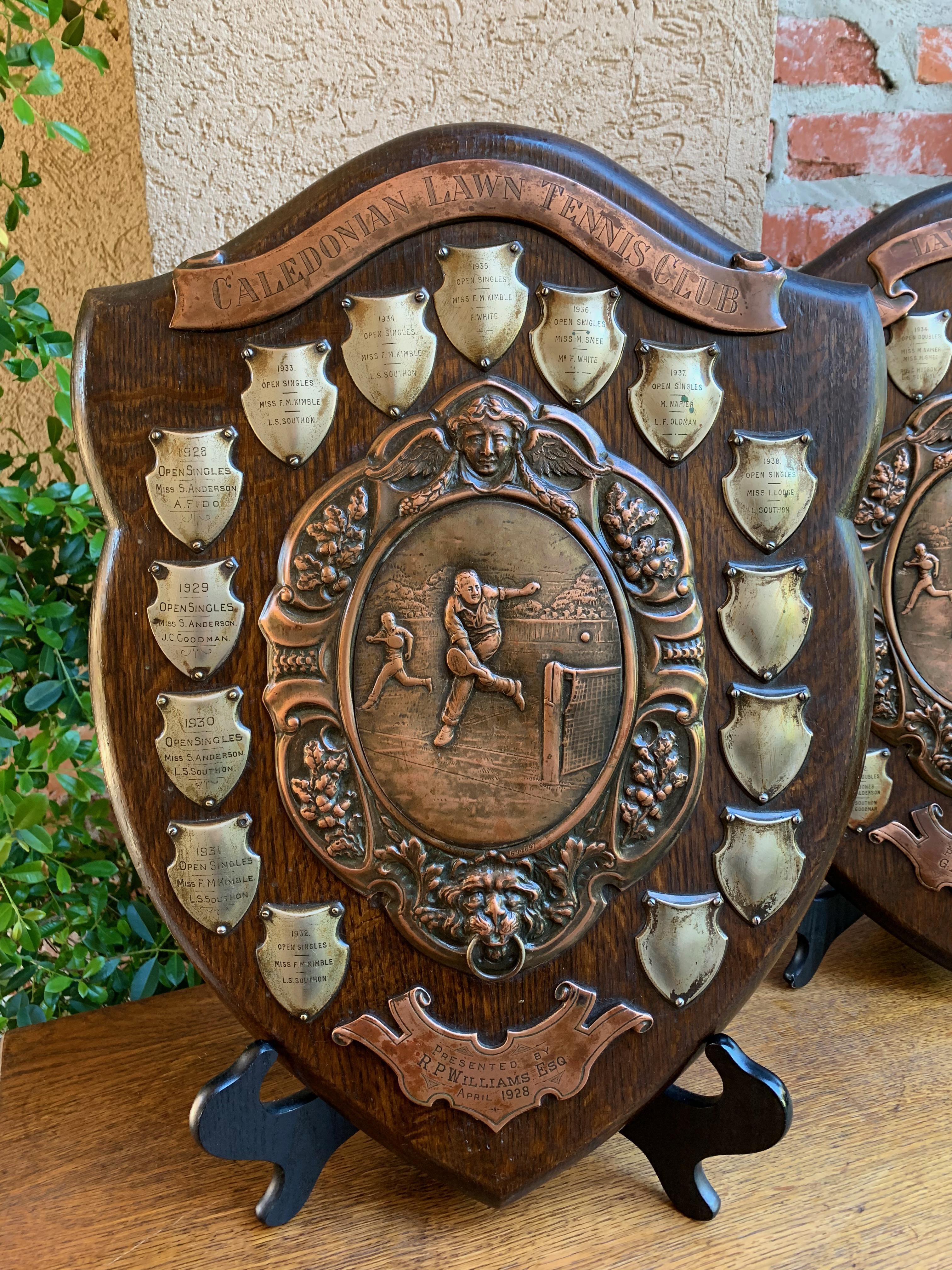 Direct from England, a one-of-a-kind English tennis club wall plaque!
~This big wood shield trophy has copper upper and lower banners that engraved:
Caledonian Lawn Tennis Club
Presented by R. P. Williams, Esq
April, 1928

The Caledonian Lawn