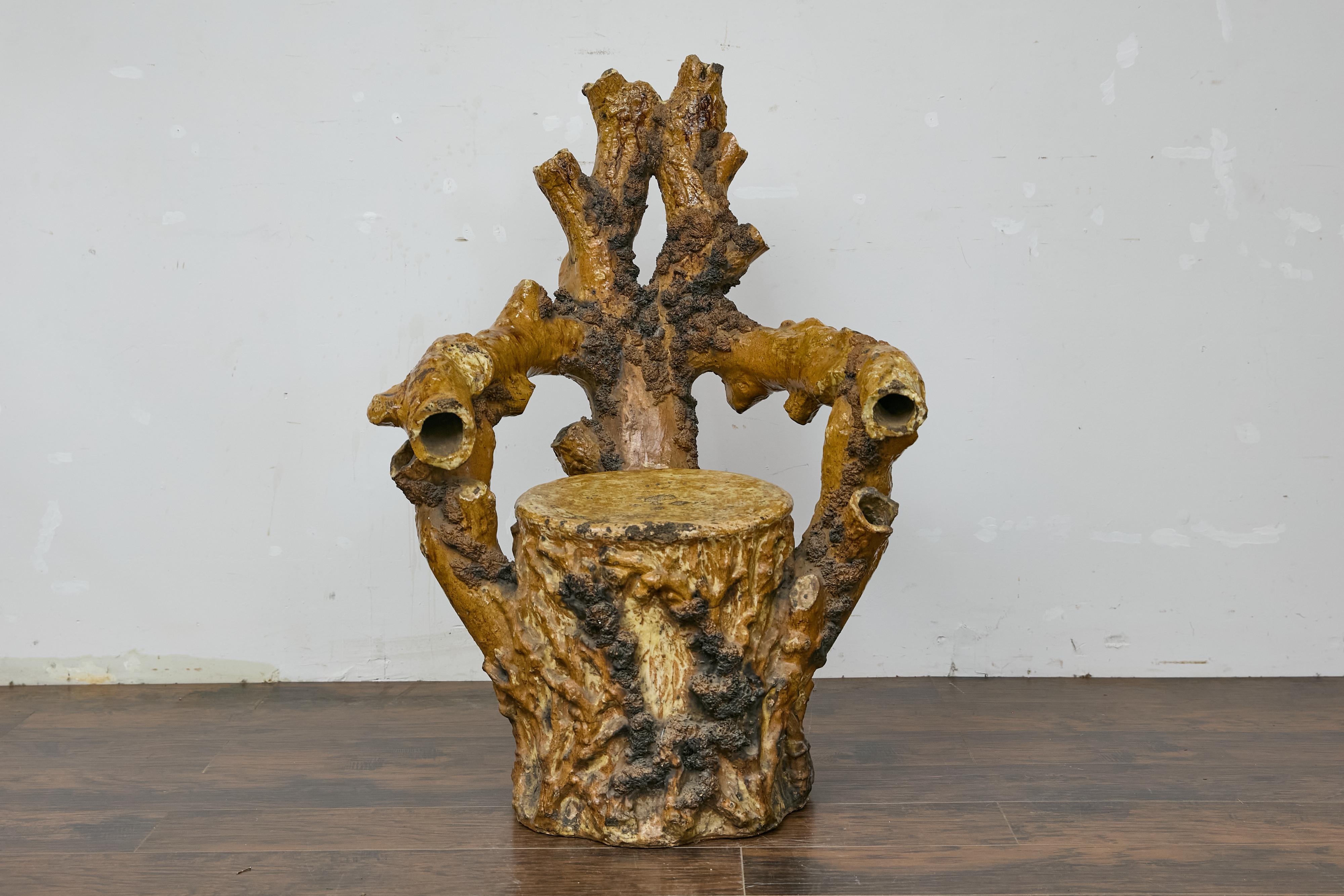 An English terracotta coral inspired Grotto chair from circa 1900. This whimsical English terracotta Grotto chair from circa 1900 captures the imagination with its coral-inspired design, resembling a striking piece of marine life sculpted from the