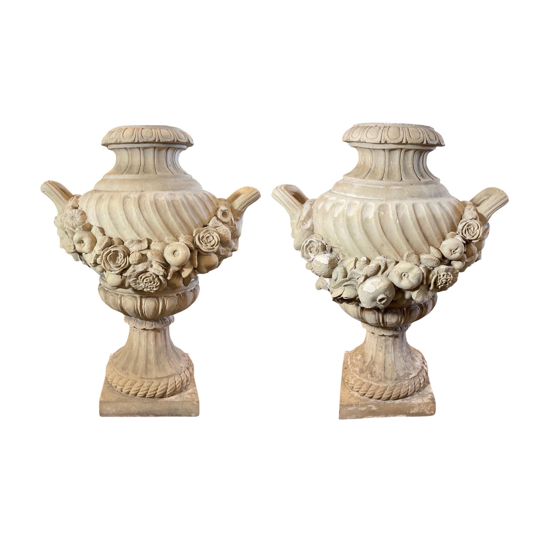 These English Terracotta Planters are the perfect addition to your outdoor space. Featuring an elegant terracotta style with carved floral and face designs, these planters come as a pair and will add a touch of sophistication to your garden. circa