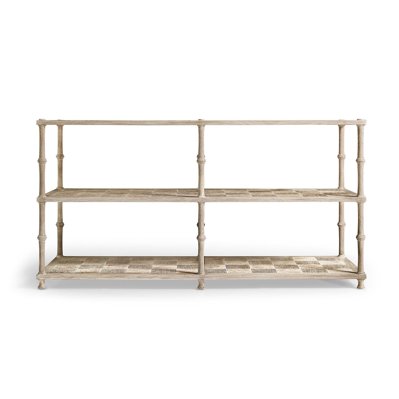 A timeless blend of design and craftsmanship. Made from acacia wood, its tiered shelves feature a classic parquetry pattern, while the washed finish highlights the wood grain. The open, reeded shelves offer an elegant display for decor and