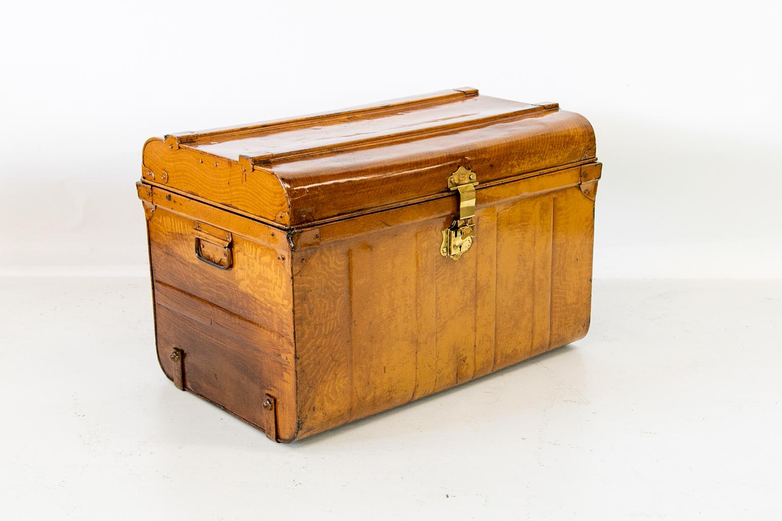 English tin travel trunk is signed “E. Bates. Patent 12552 West Hampton”. It has the original brass hasp and the original faux painting designed to simulate wood grain. The interior is Chinese red.   
  