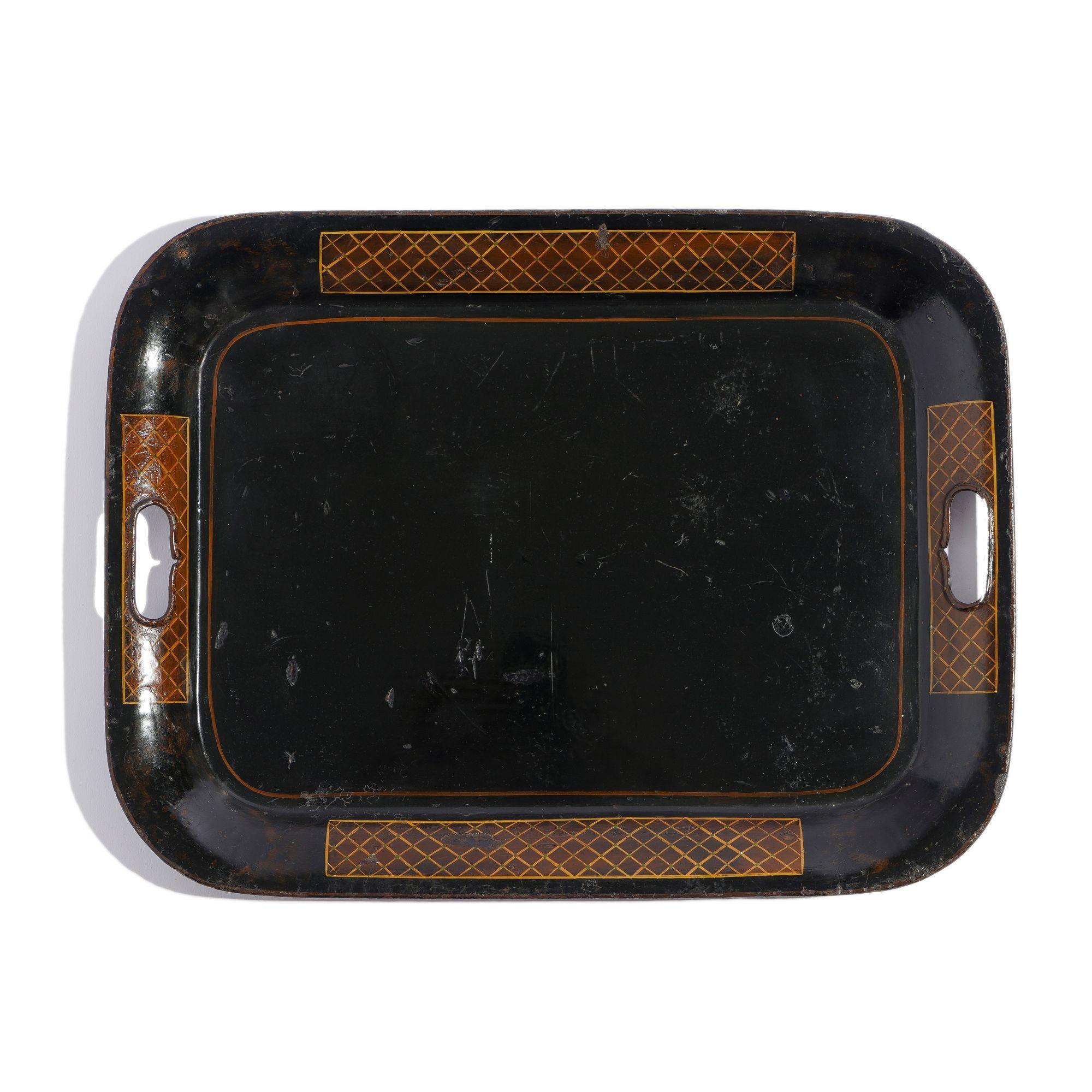 Rectangular tole tea tray with rolled rim painted with diapered reserves and pierced on the narrow ends with handle grips.
England, circa 1840.