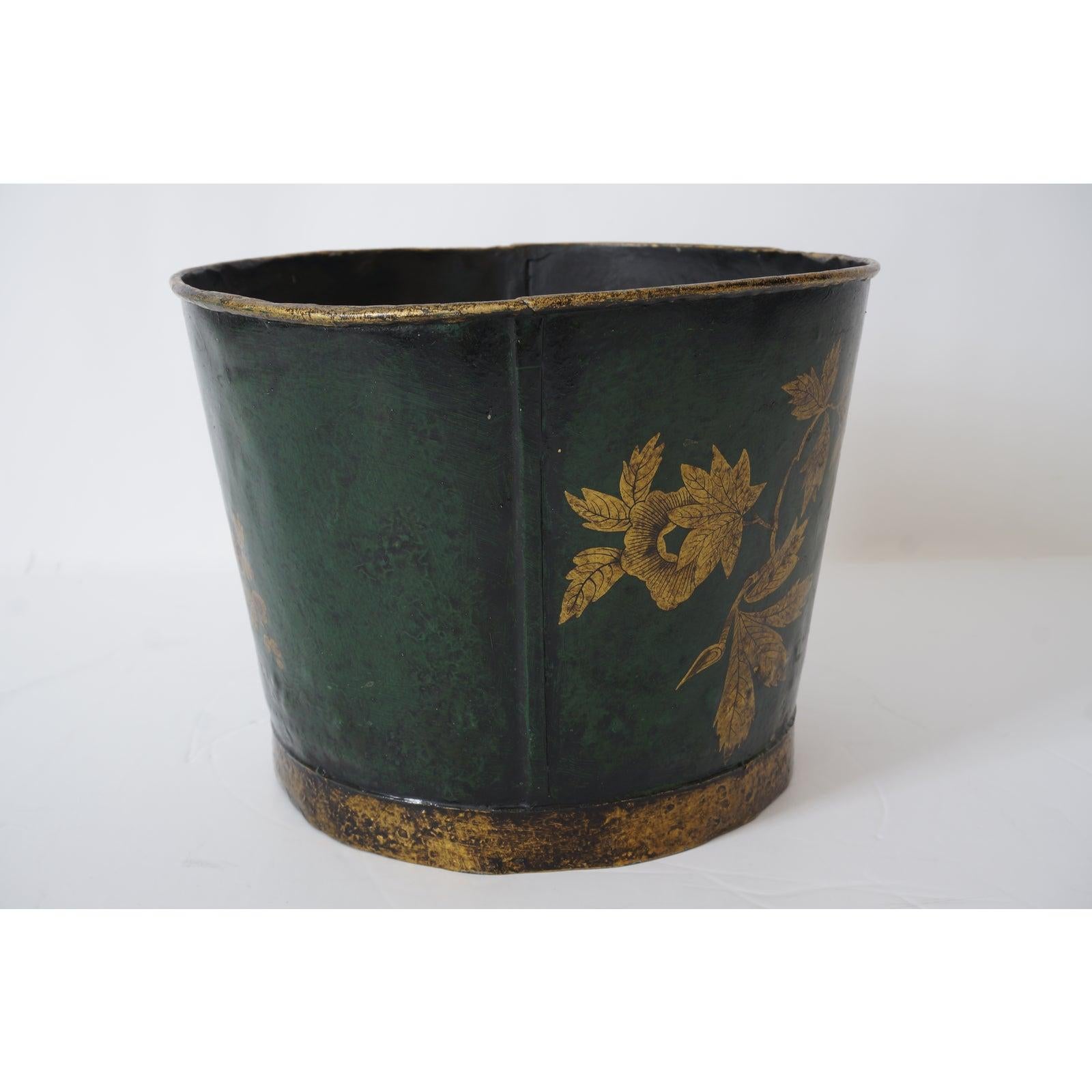 This stylish anc charming toleware bucket dates to the late 19th century and is hand painted in emeral green with gilt-gold butterfles, foliage and trim.

Note: Dimensions are 8.50