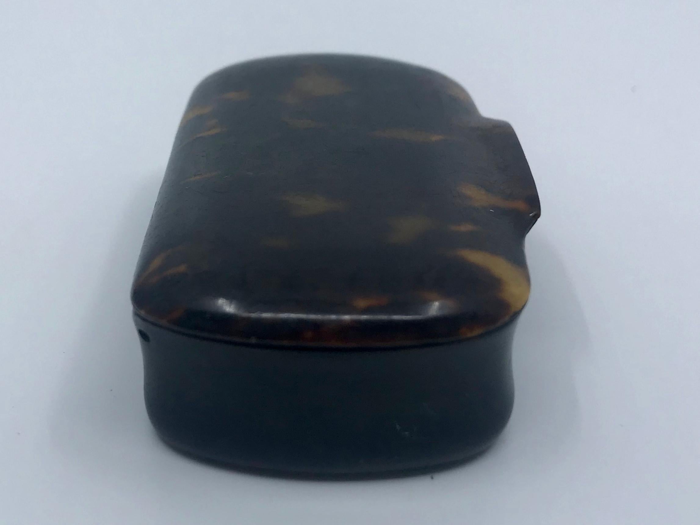 English tortoiseshell box. Ovoid shaped lidded snuffbox with integral handle of richly patterned tortoiseshell, England, circa 1900.
Dimensions: 3.5