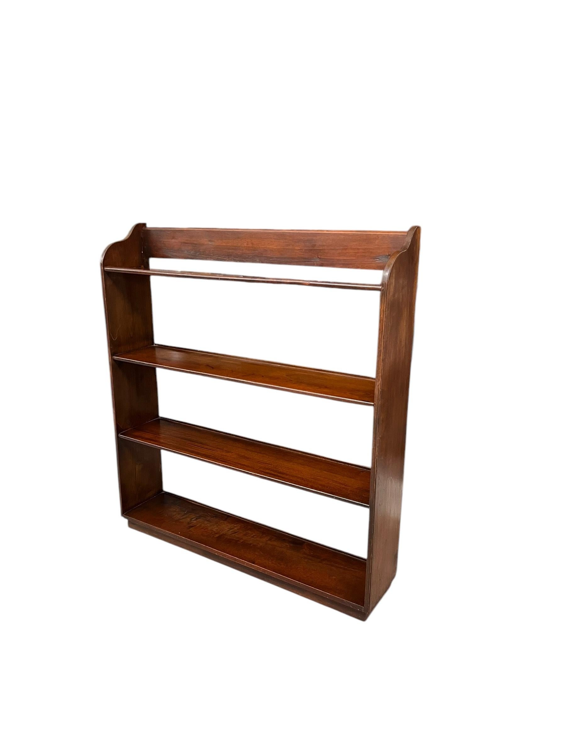  This English Arts and Crafts style wood bookcase features a rich Mahogany finish, showcasing a warm, deep color that highlights the natural grain of the wood. The design is characterized by its simplicity and functional elegance, typical of the