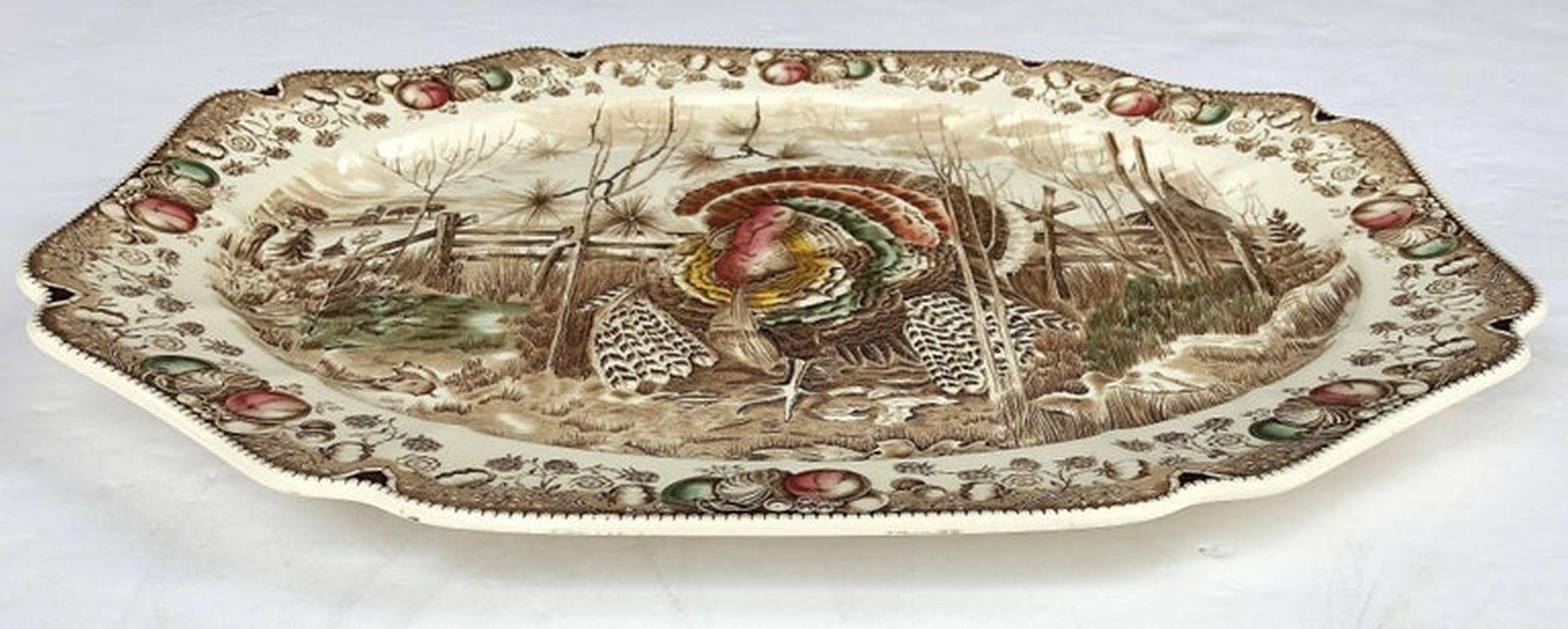 A large vintage serving platter featuring the Wild Turkey, his majesty brown and white transfer-ware pattern by the celebrated English pottery firm, Johnson Brothers.

With authentic midcentury brown label on reverse.

Perfect for the Thanksgiving