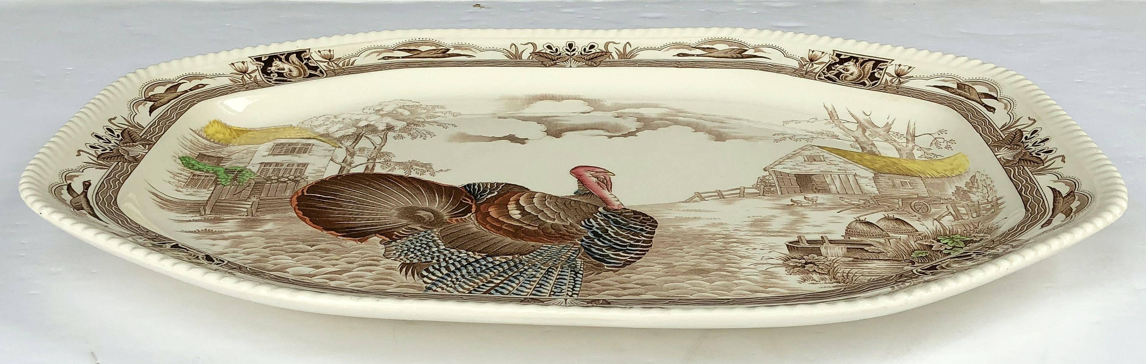 A large vintage serving platter featuring the wild Turkey, Barnyard King brown and white transfer-ware pattern by the celebrated English pottery firm, Johnson Brothers.

With authentic midcentury brown label on reverse.

Perfect for the Thanksgiving