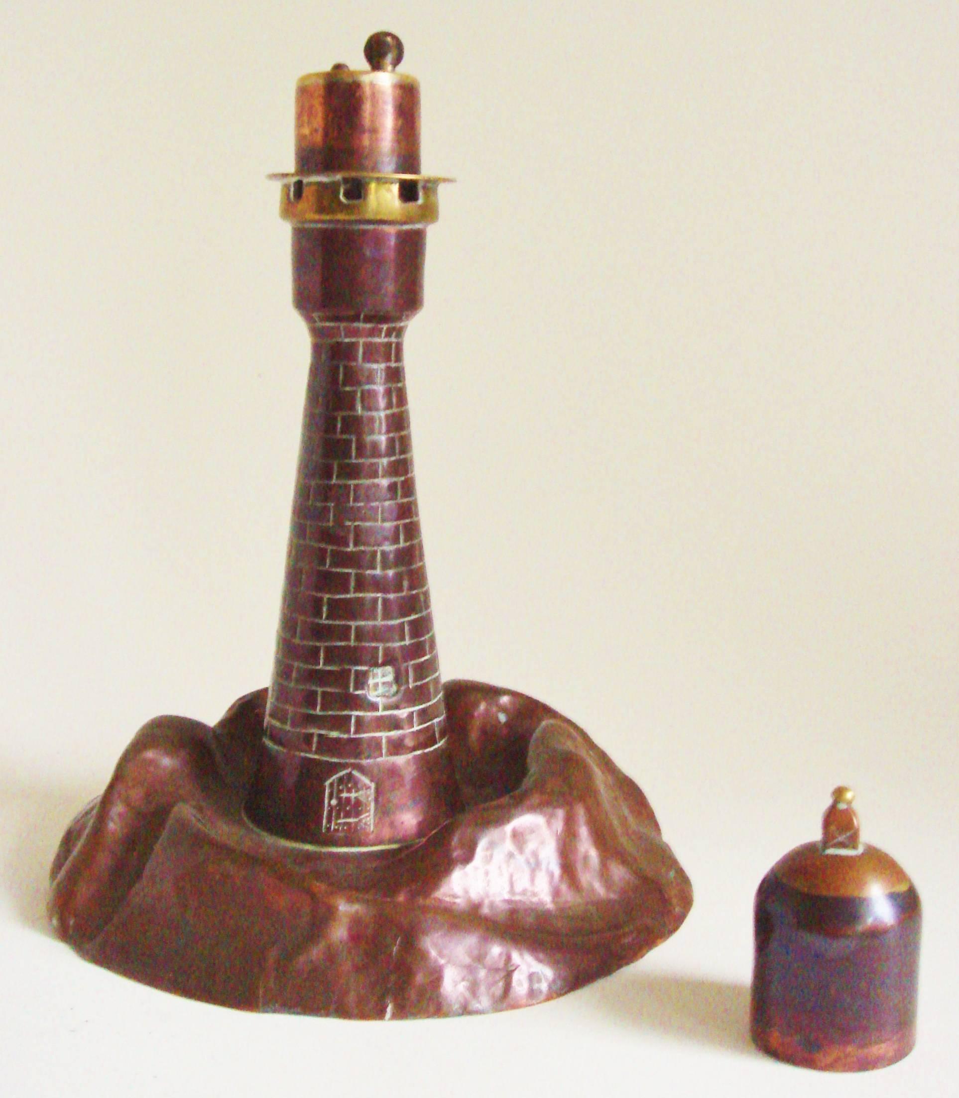 This Trench Art figurative wheel and flint table lighter is beautifully modeled in the form of a brick lighthouse standing on a rocky outcrop all in solid bronze. The door, bricks and window details have been primitively incised into the bronze