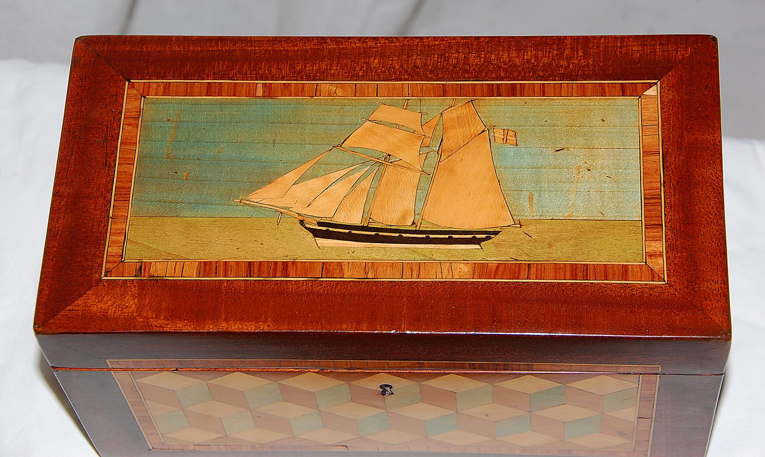 English Trinity House mahogany tea caddy. Stained boxwood two masted sailing ship in calm waters inlaid to lid, within kingwood crossbanded border outlined with boxwood. The front and two sides (not the back) are parquetry inlaid stained boxes,