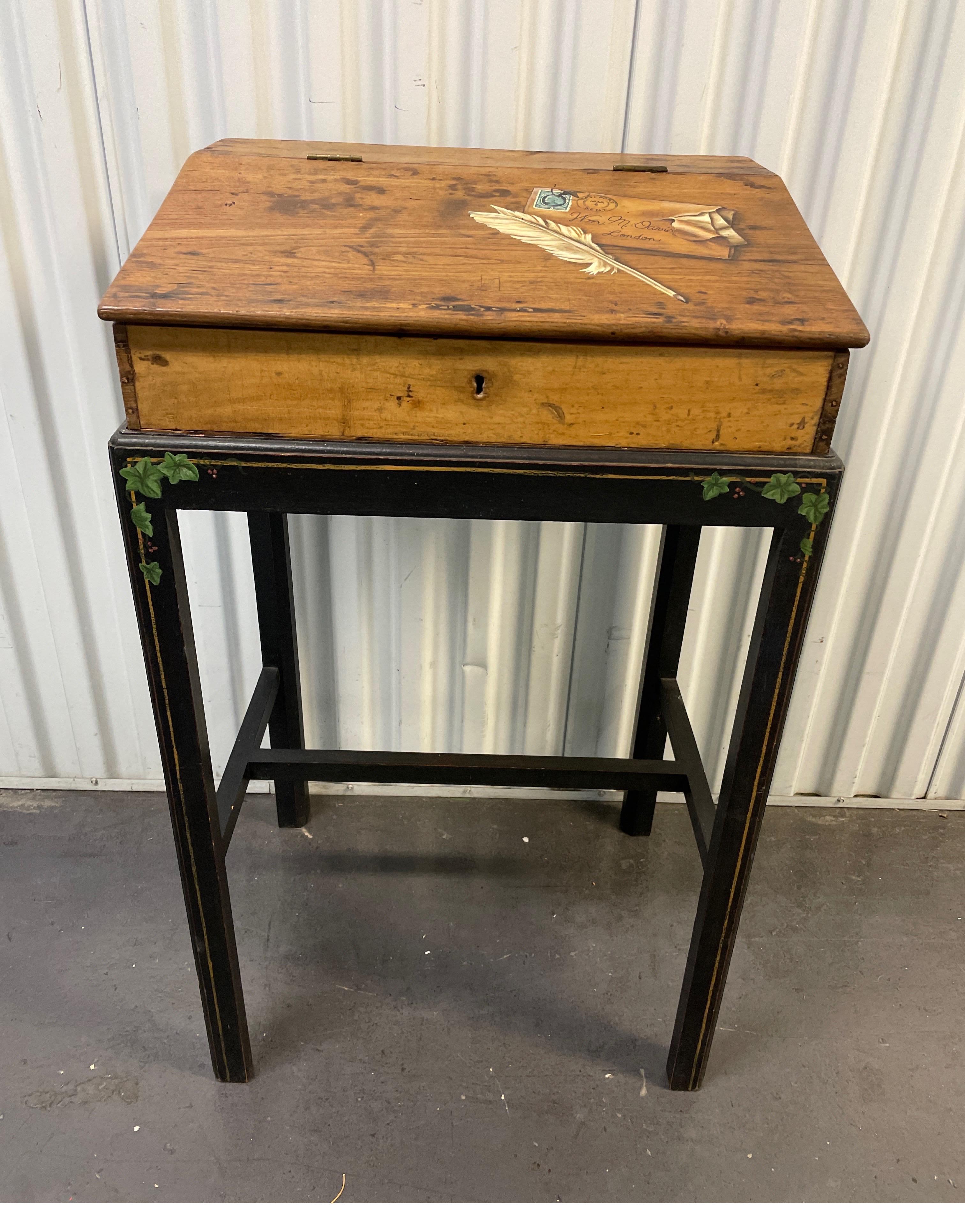 Charming Trompe L'0eil painted lap desk on stand. Top features a letter & quill pen. The legs of stand have hand painted ivy. Top hinges open to storage compartment.