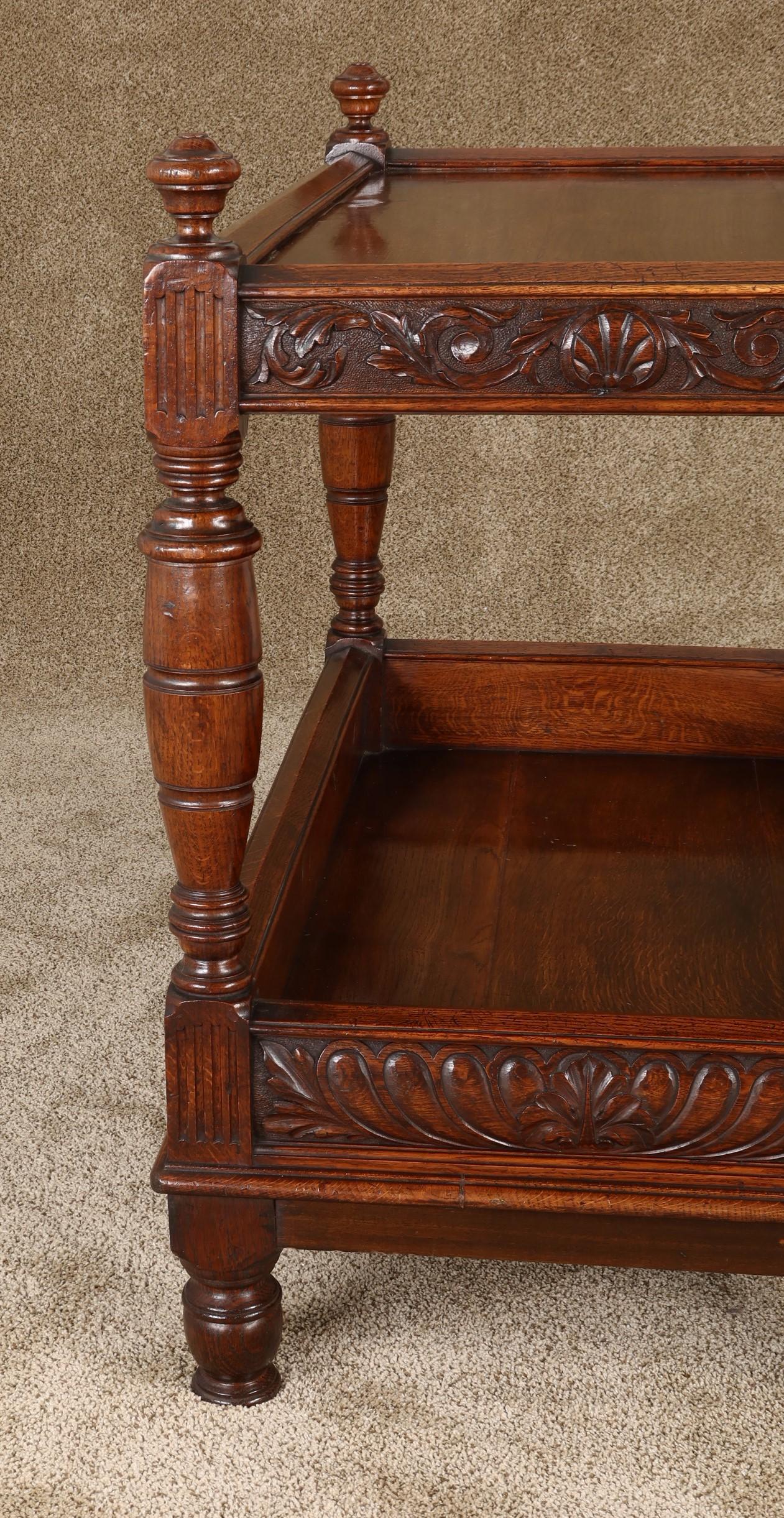 Antique English Tudor Revival well-carved oak server with two tiers, turned uprights and feet. A very useful serving piece of good color and patina,
circa 1890.