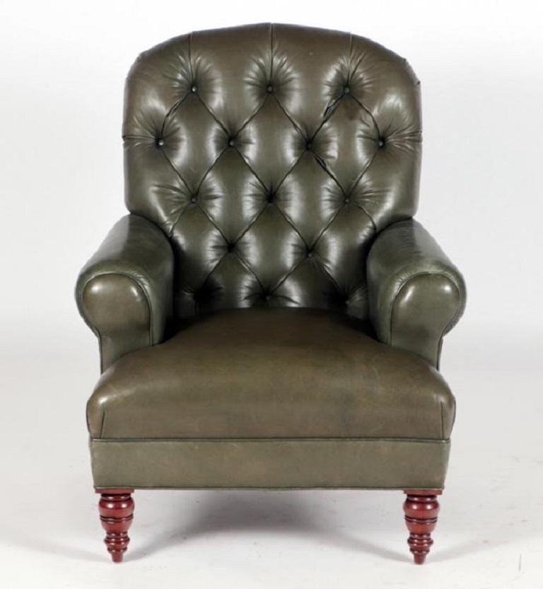 English tufted leather side chair. The chair has rolled arms, heavy tufted back with solid walnut legs. Club chair.