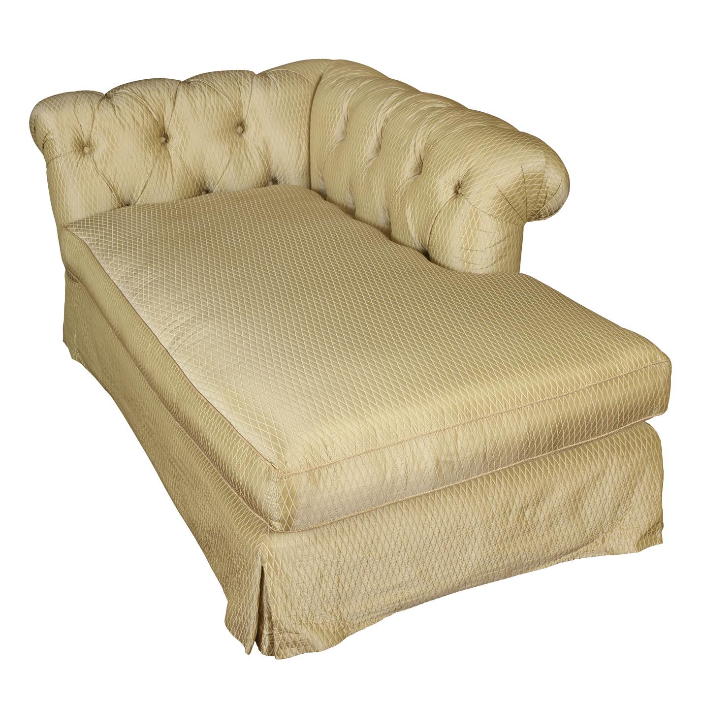 English upholstered tufted chaise with curved back in neutral diamond patterned fabric.