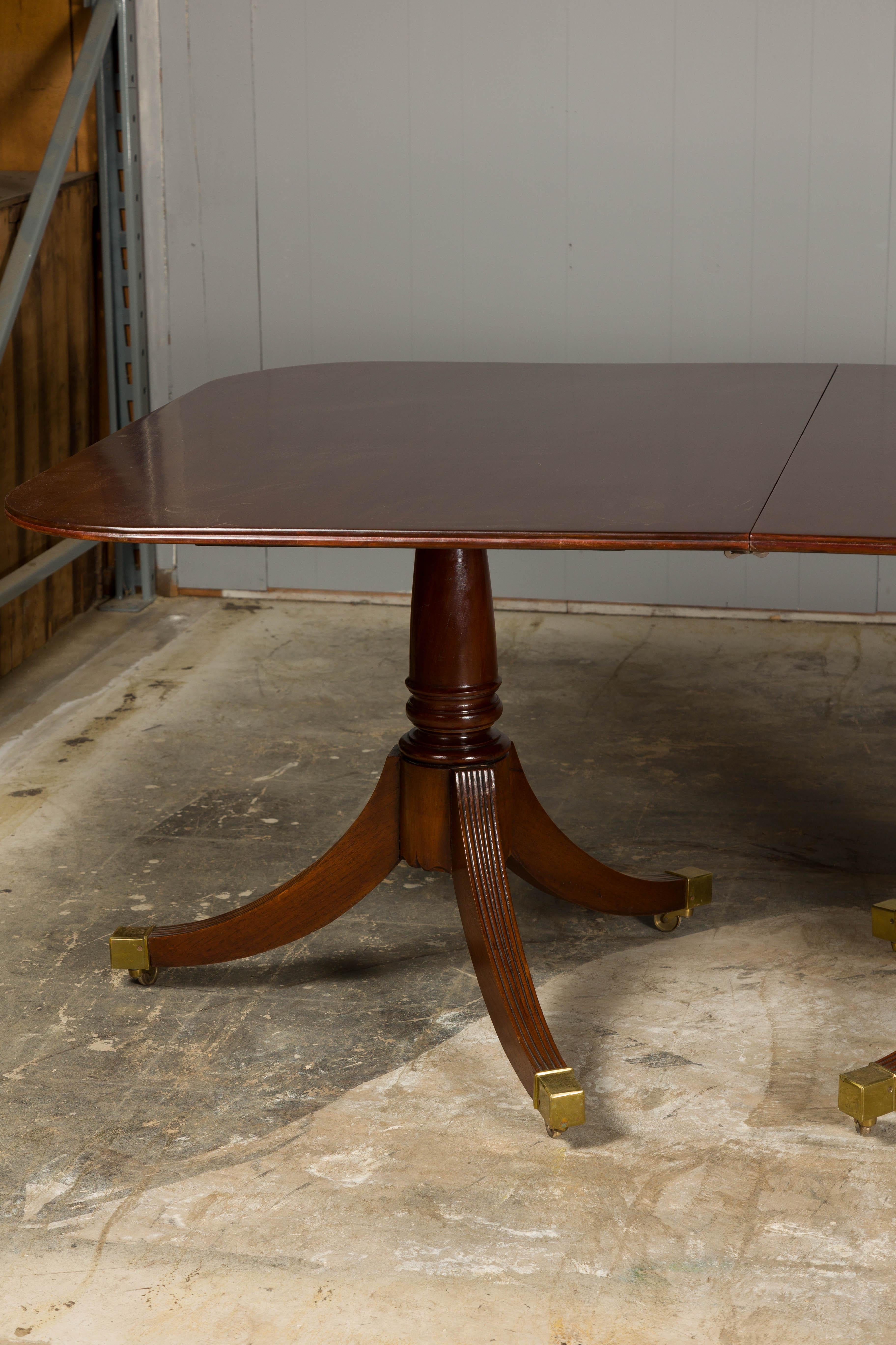 Carved English Turn of the Century Mahogany Extension Dining Table with Quadripod Base For Sale