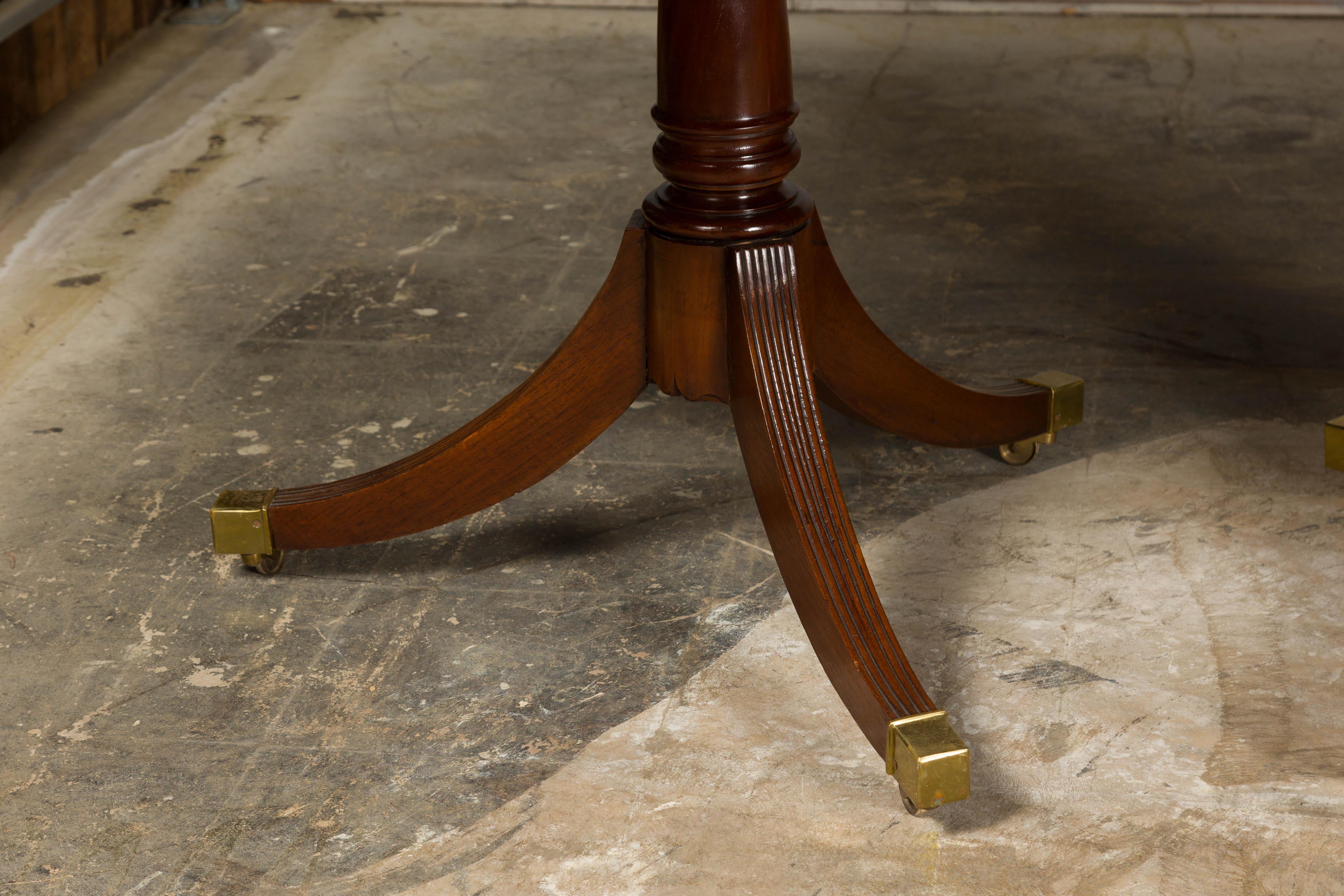 Brass English Turn of the Century Mahogany Extension Dining Table with Quadripod Base For Sale