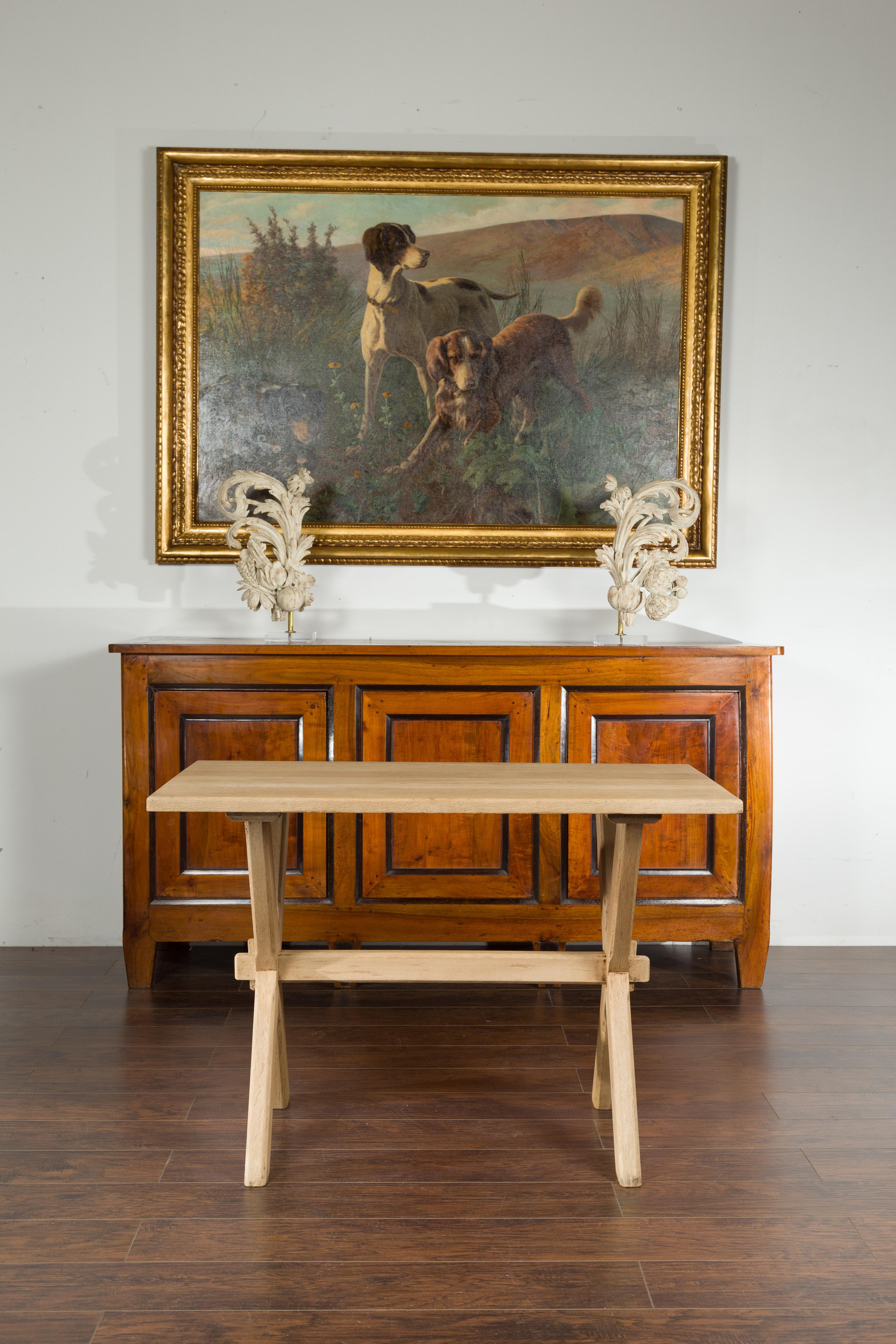 An English oak sawbuck table from the Turn of the Century, with X-form base. We currently have two tables available, priced and sold each $5,650 (see image 3 to view them both). Created in England during the early years of the 20th century, this
