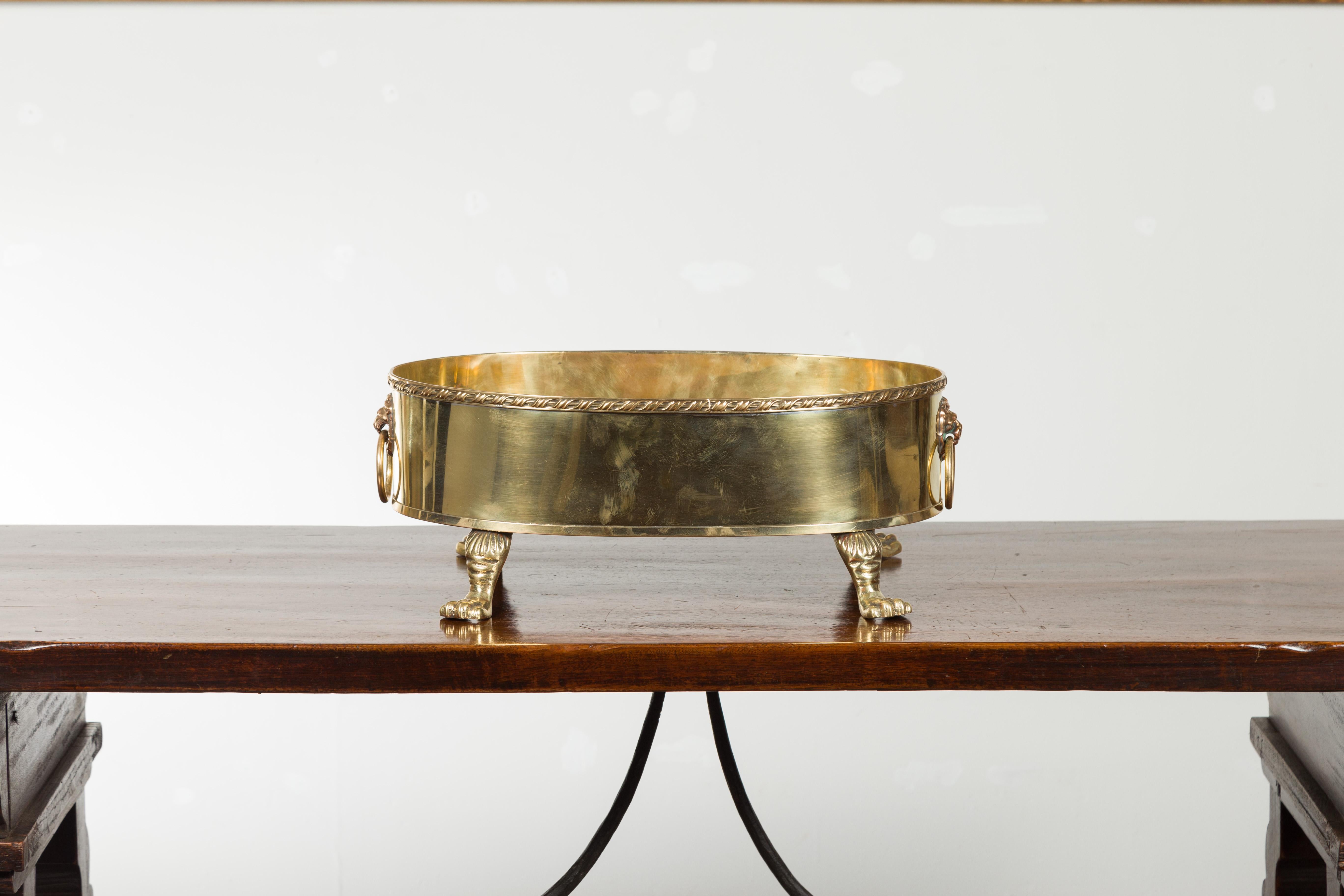 20th Century English Turn of the Century Oval Brass Cachepot with Lion Heads and Paw Feet