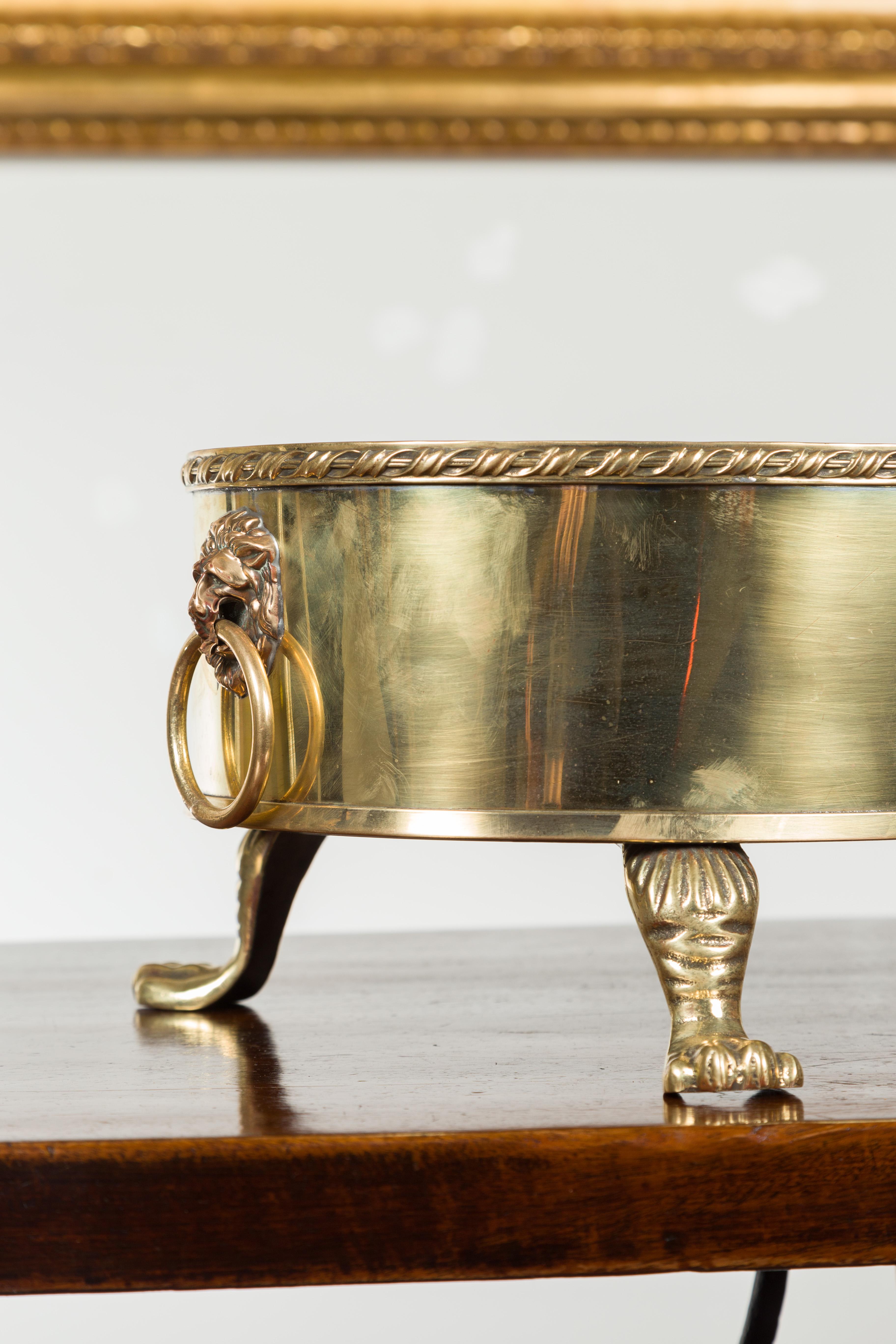 English Turn of the Century Oval Brass Cachepot with Lion Heads and Paw Feet 4
