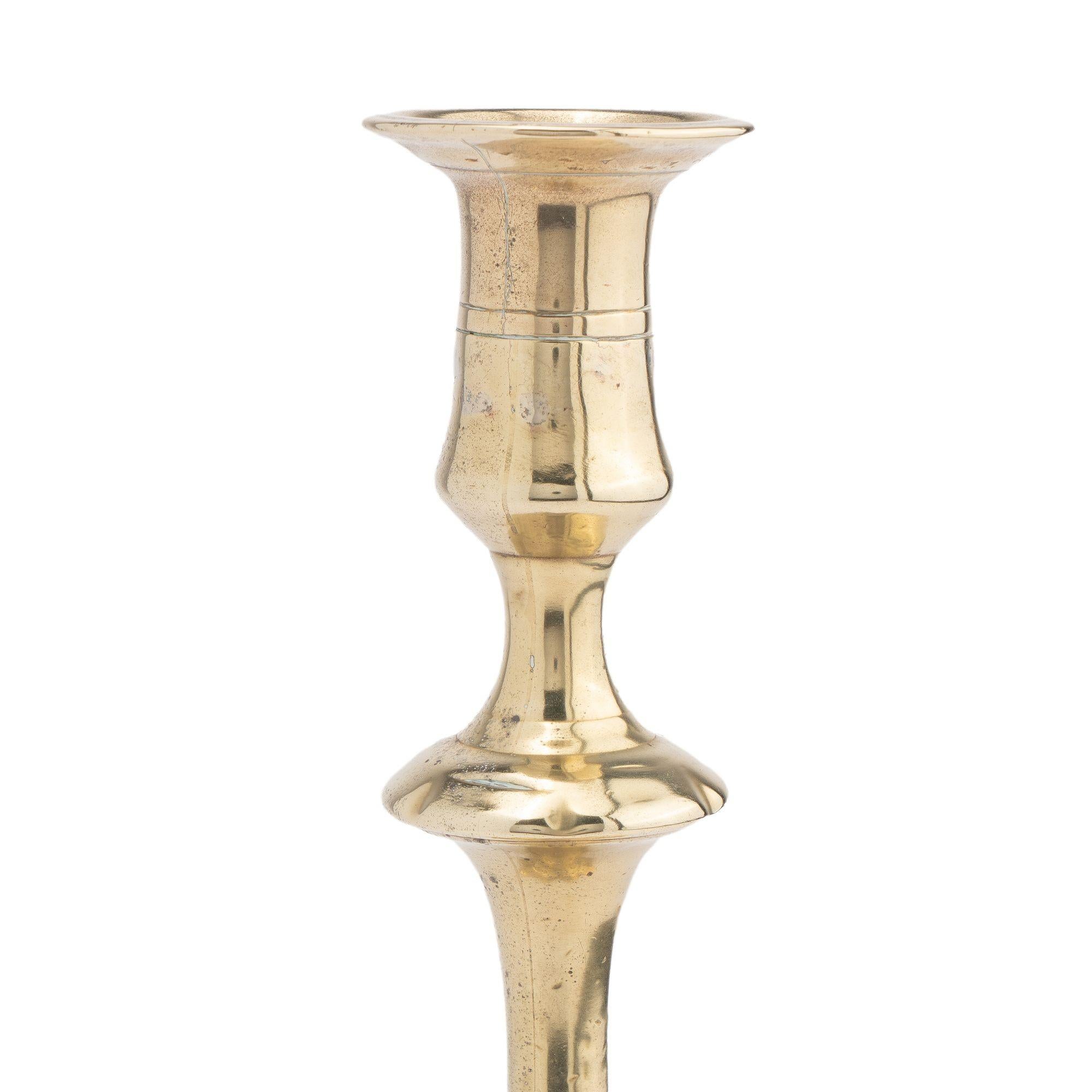 British English two part seamed cast brass petal base candlestick, 1760 For Sale