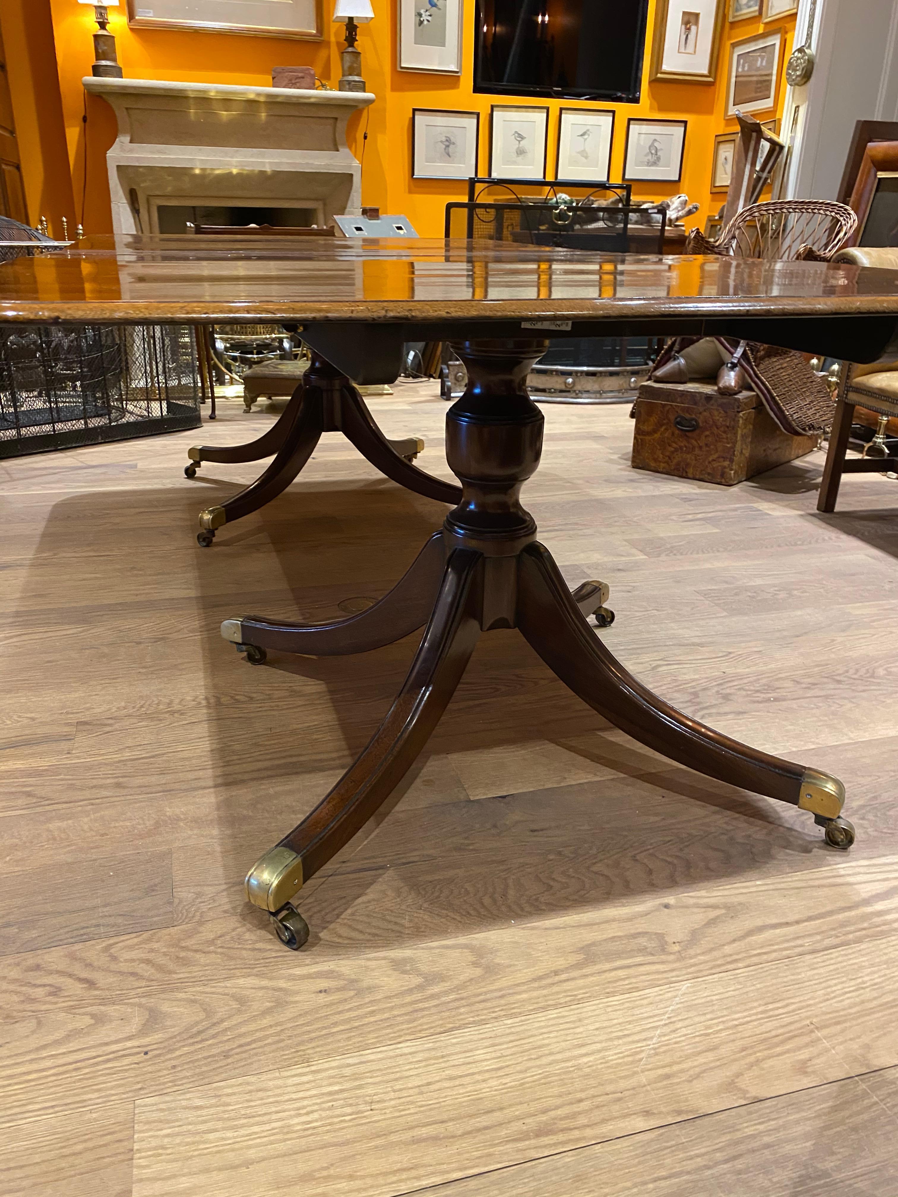 English Regency two pedestal dining table. Table has two mahogany leaves.