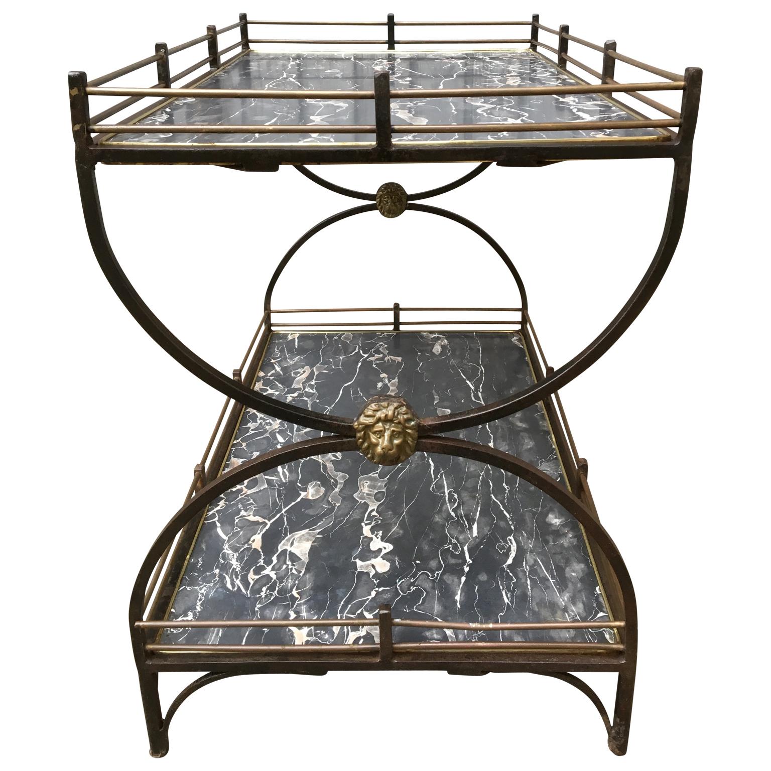 English two-tier Mid-Century Modern brass and iron bar cart with lion heads

The wooden shelves have a faux black marble linoleum sheet covers. 

         