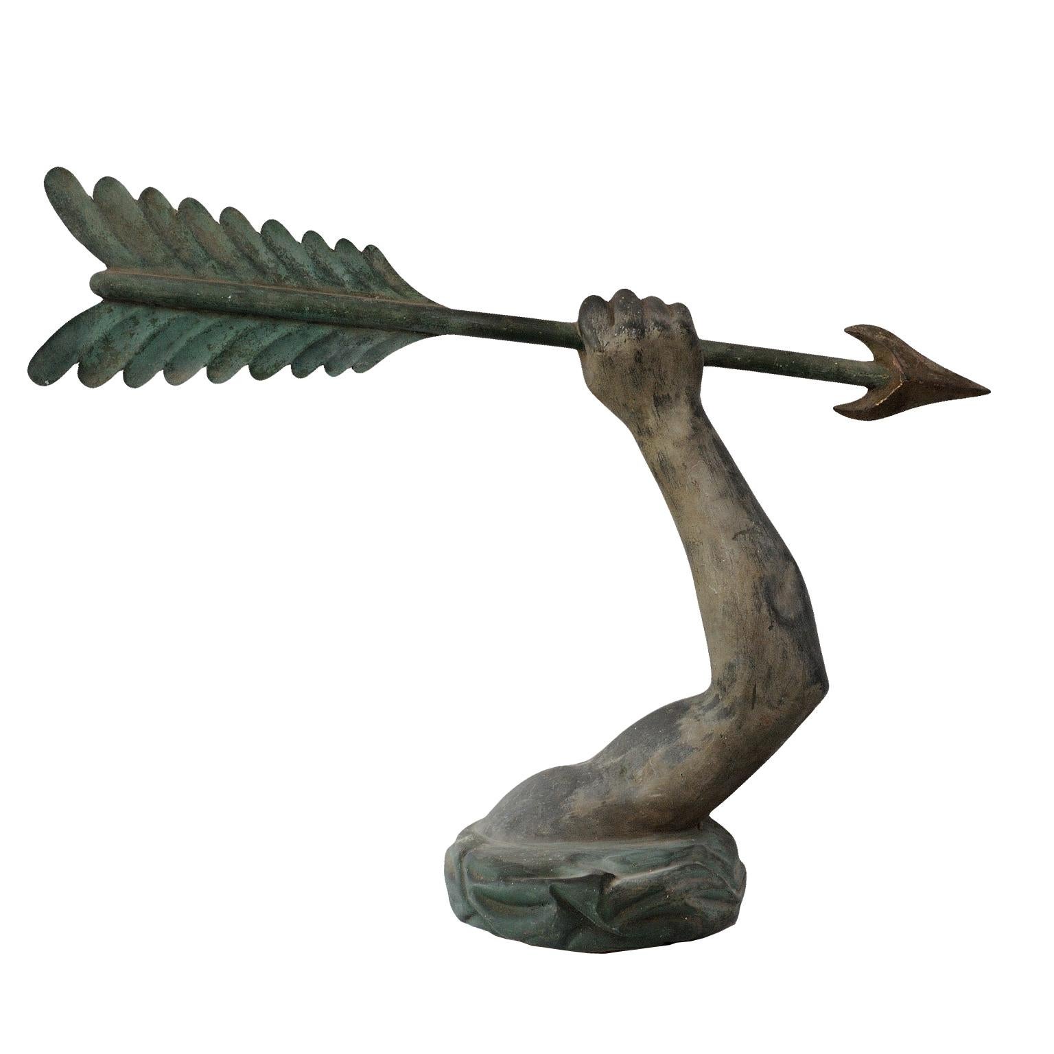 This is a wonderful early 19th century English verdigris copper Armorial finial removed from the top of a massive baronial weather vane. A compressed Turkish turban surrounded by an erect arm holding an arrow, suggesting the family had been on