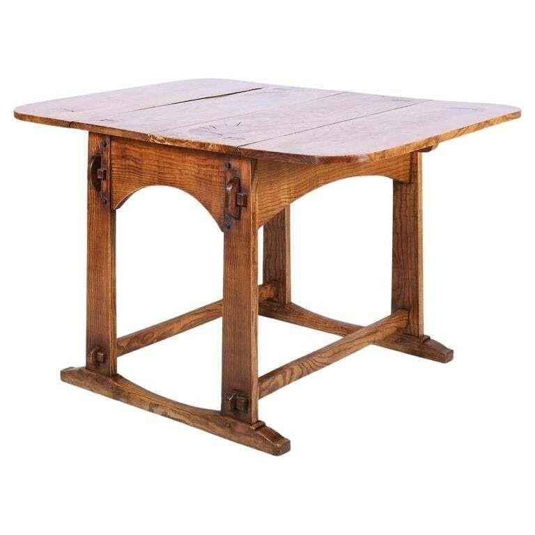 A fine English Cotswold School vernacular center table made of field ash, showing off the maker's skills. It features great design and craftsmanship. The timber has substantial heft, vivid graining and superb color. Shaped aprons and footed