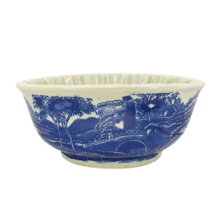 A beautiful antique blancmange fish mold. A lovely example of Victoria Ware, this heavy ironstone dish could serve as a planter, or even to display on a wall. The sides are decorated in a deep blue design of the English countryside on a cream