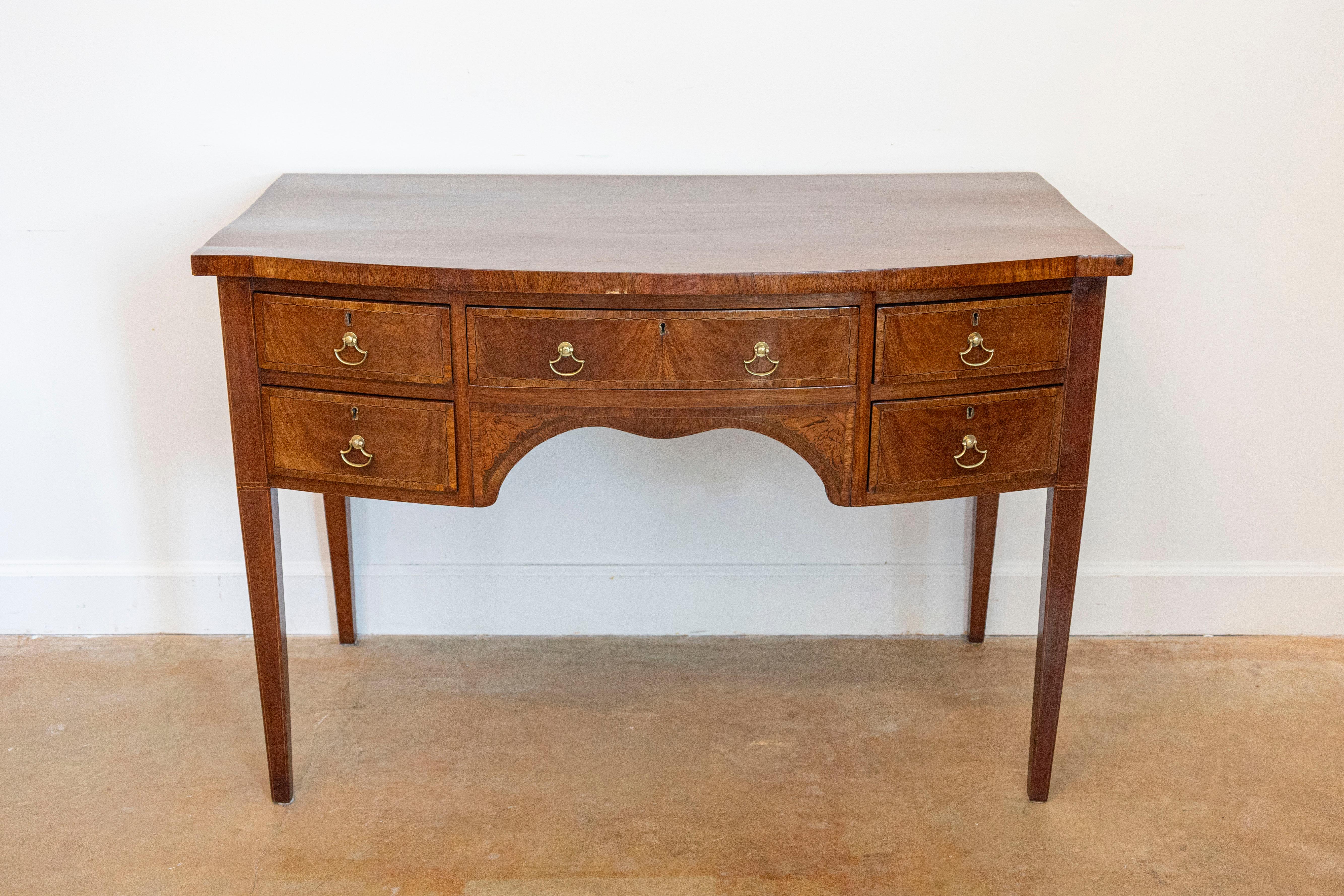 An English walnut and mahogany bowfront sideboard circa 1860 with five drawers. Immerse yourself in the charm of the Victorian era with this English walnut and mahogany bowfront sideboard, circa 1860. With a blend of aesthetics and functionality,