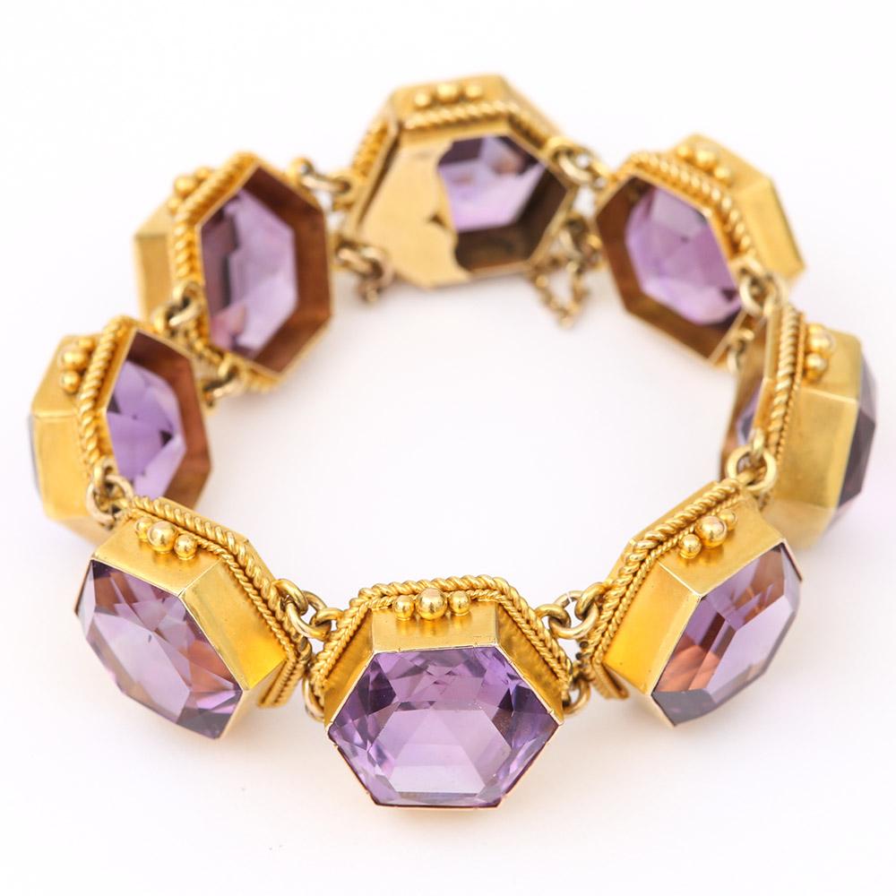 A stunning 15 Karat yellow gold Victorian amethyst bracelet displaying eight large faceted amethysts. Each gemstone ranging between 17mm and 20mm in diameter contained within a hexagonal 15k gold mount with a double rope edge and triple granulated