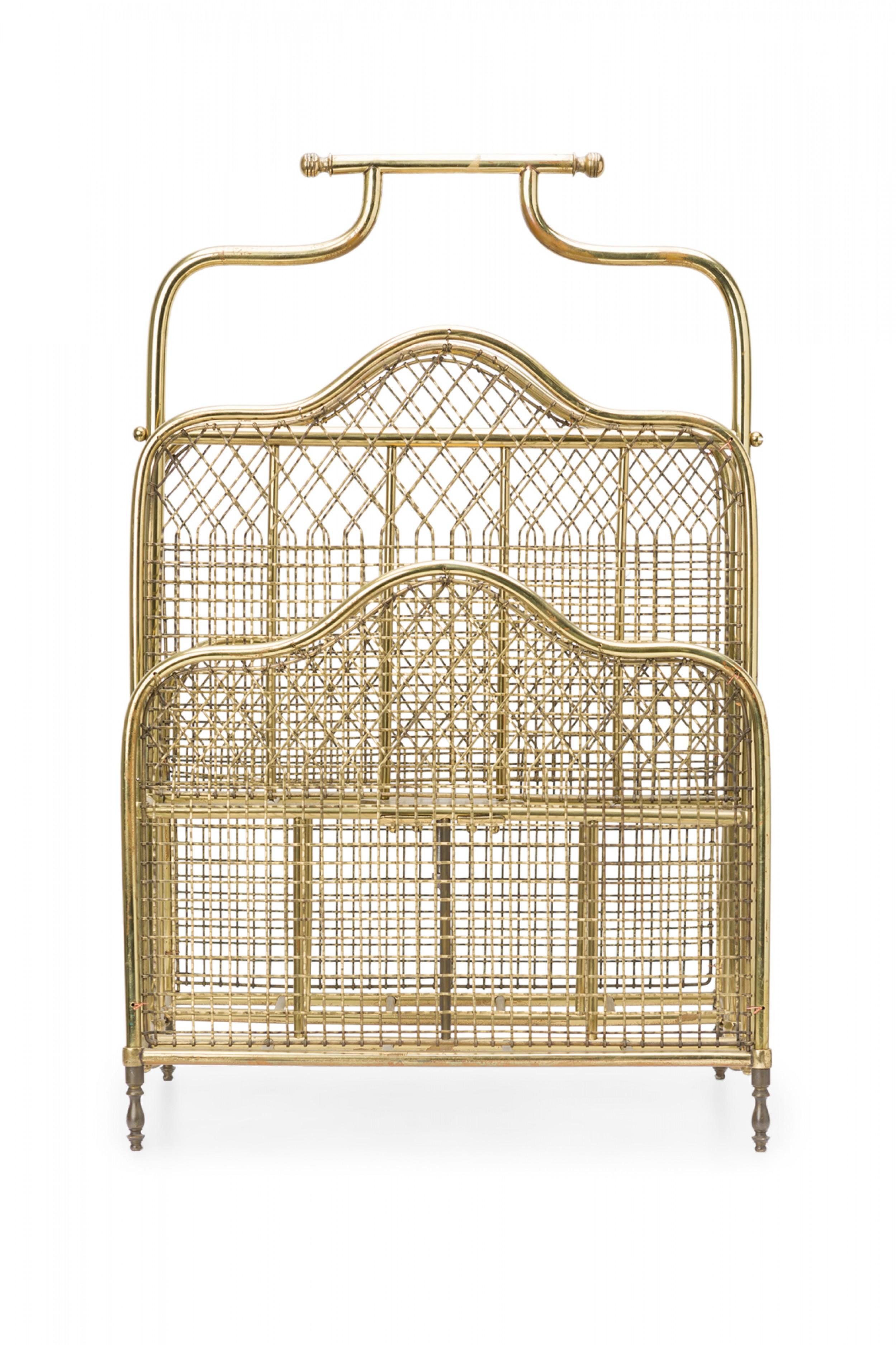 English Victorian-style magazine rack with a brass frame and handle and three tiered compartments walled with brass grid mesh.
