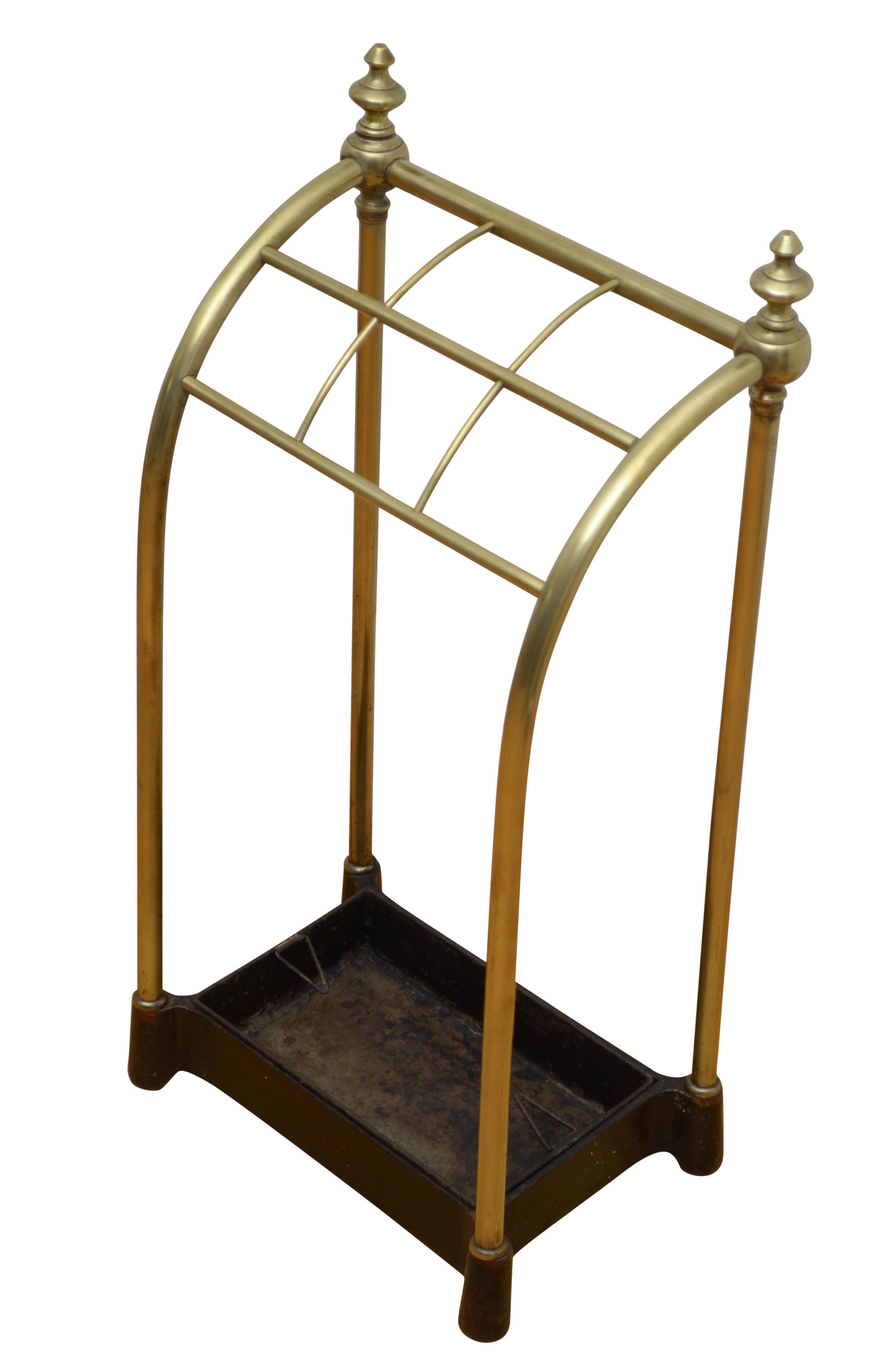 P0264 English brass umbrella stand / walking stick stand round form with six divisions, two decorative finals and removable drip tray in cast iron base. This antique umbrella stand retains its original finish, patina and antique character, all in