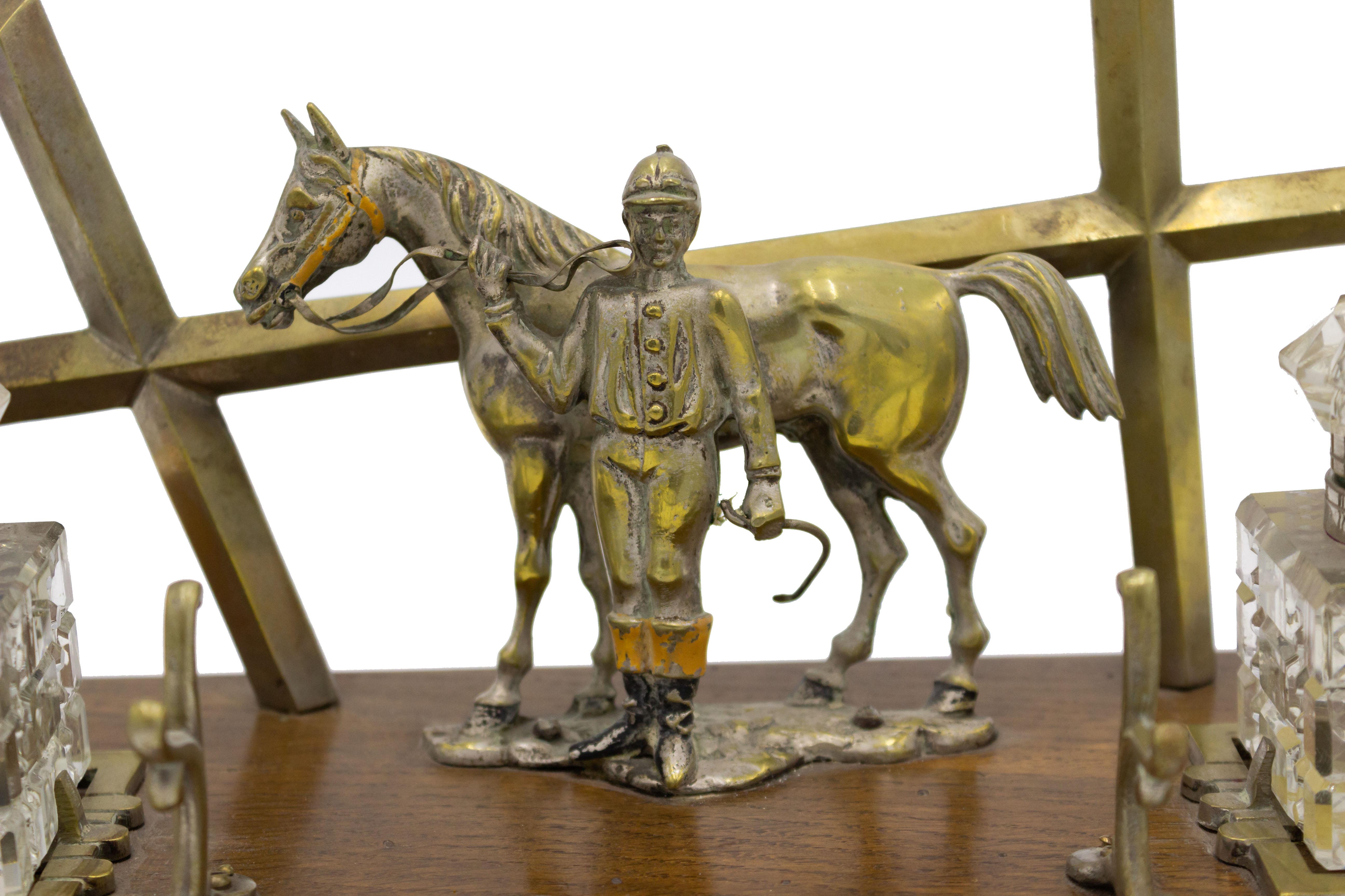 English Victorian bronze double inkwell on oak base with jockey and horse motif and crystal wells.
 