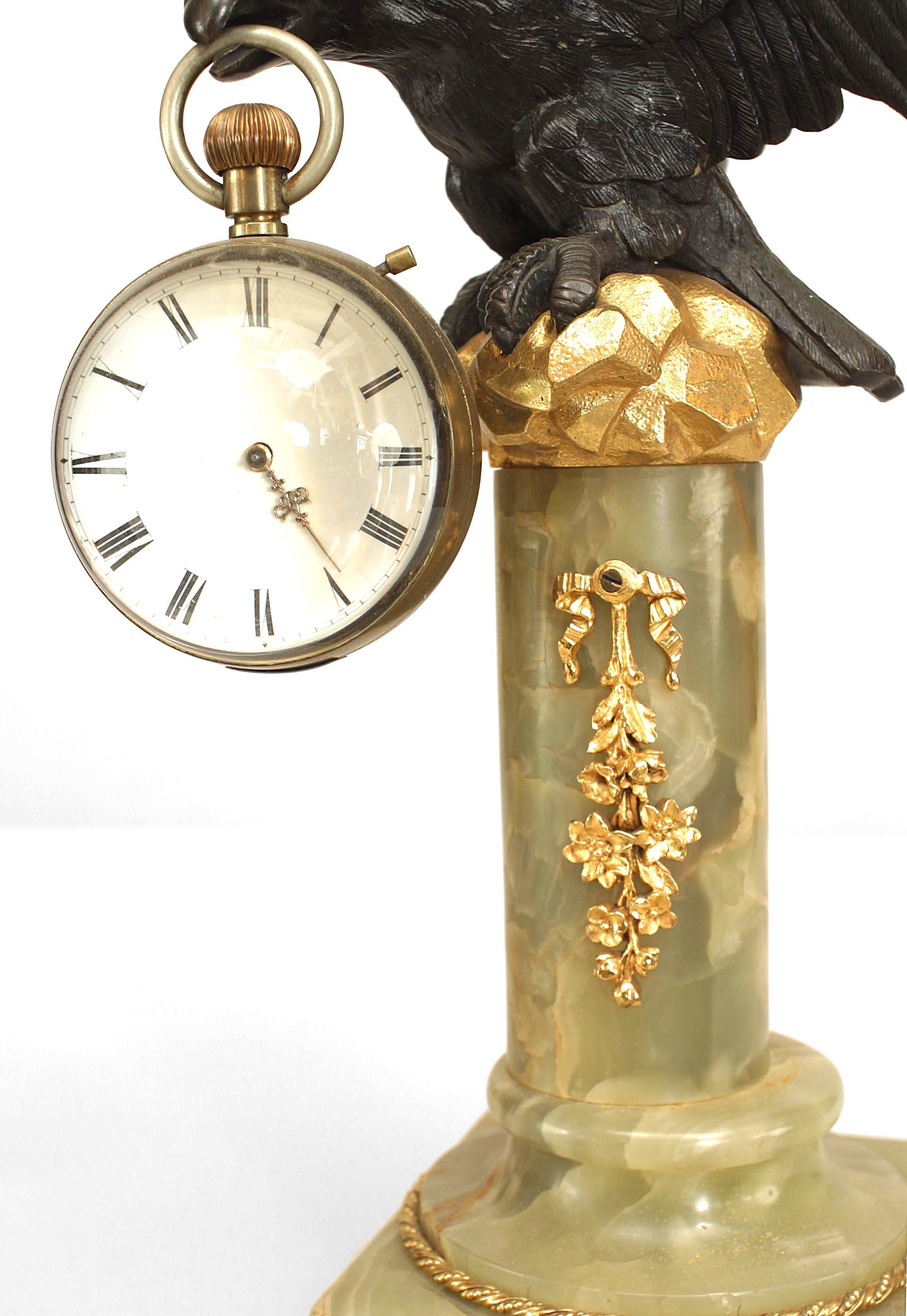 English Victorian bronze eagle holding a ball shaped desk clock perching on a bronze dore trimmed green onyx column and base. (Not working).
 