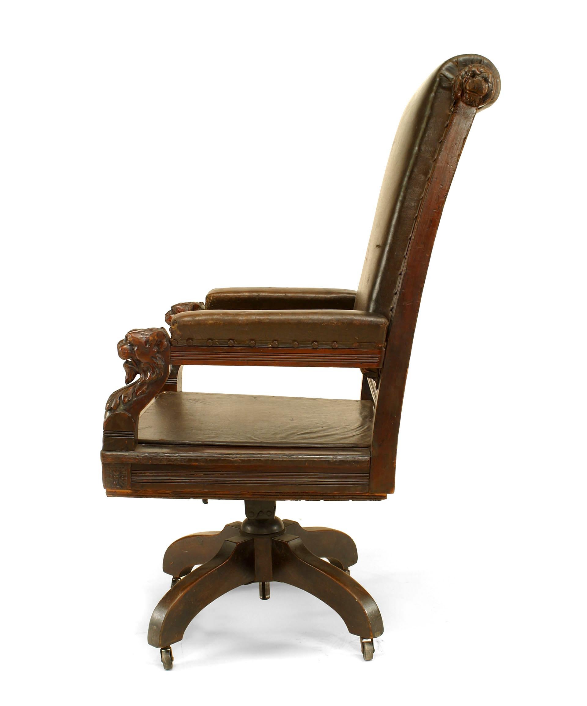 English Victorian high back brown leather judges swivel chair with carved lion heads on arms.
 