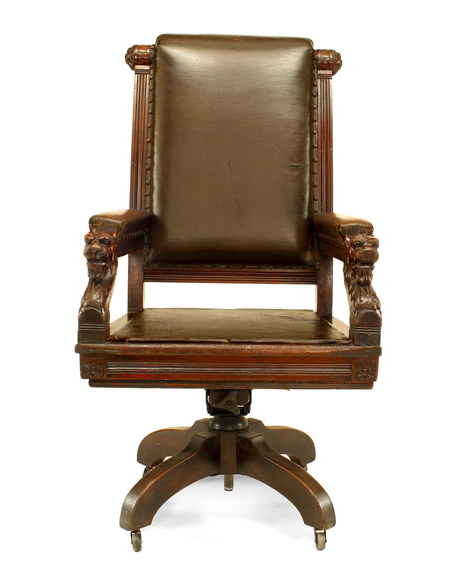 English Victorian high back brown leather judge's swivel chair with carved lion heads on arms.
