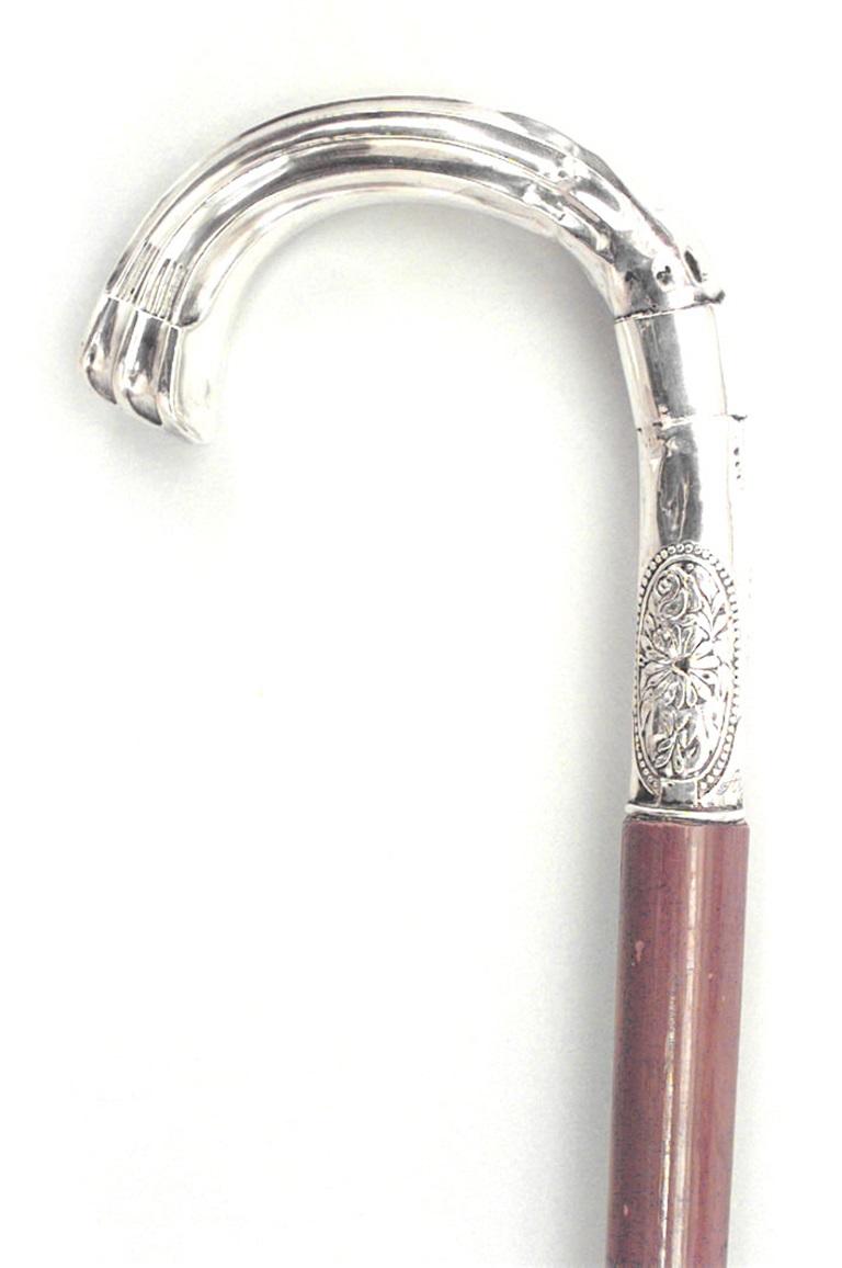 Bastone in legno chiaro in stile vittoriano con manico scanalato e medaglione floreale in argento.

Condit: (danni al manico)