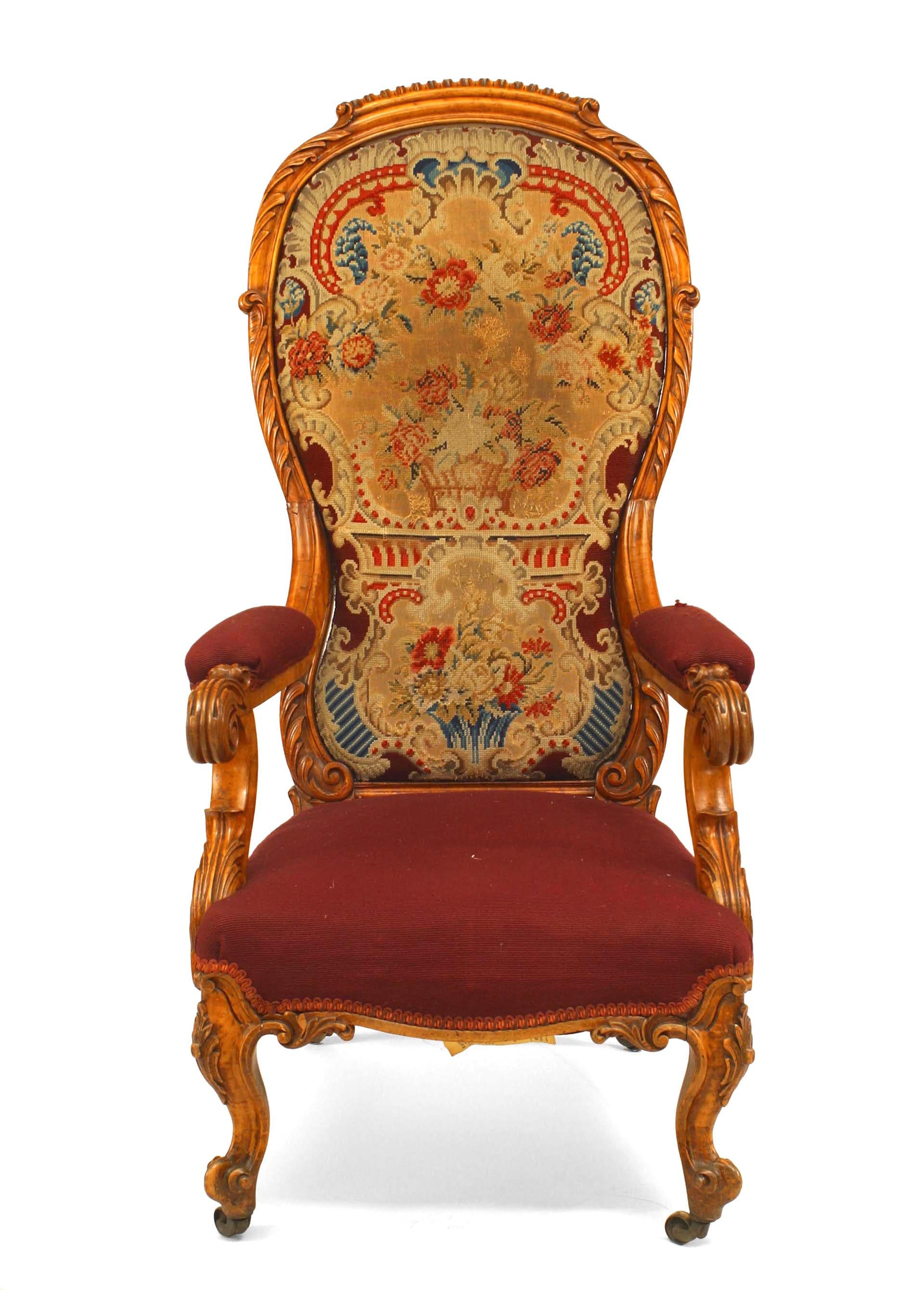 English Victorian carved satinwood high balloon shaped back arm chair with needlepoint upholstery.
