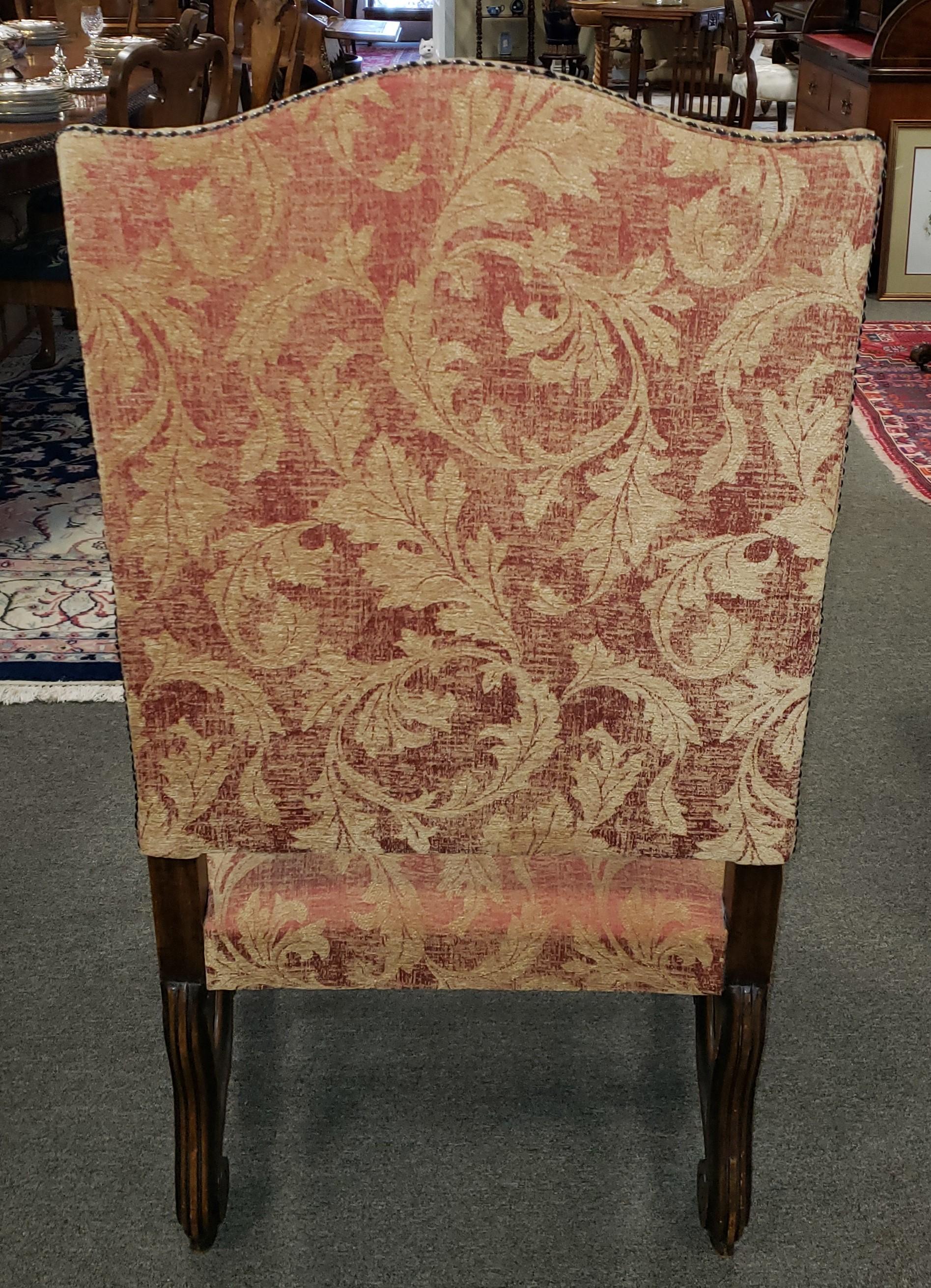 English Victorian carved walnut armchair with scroll detailing on the arms and feet.