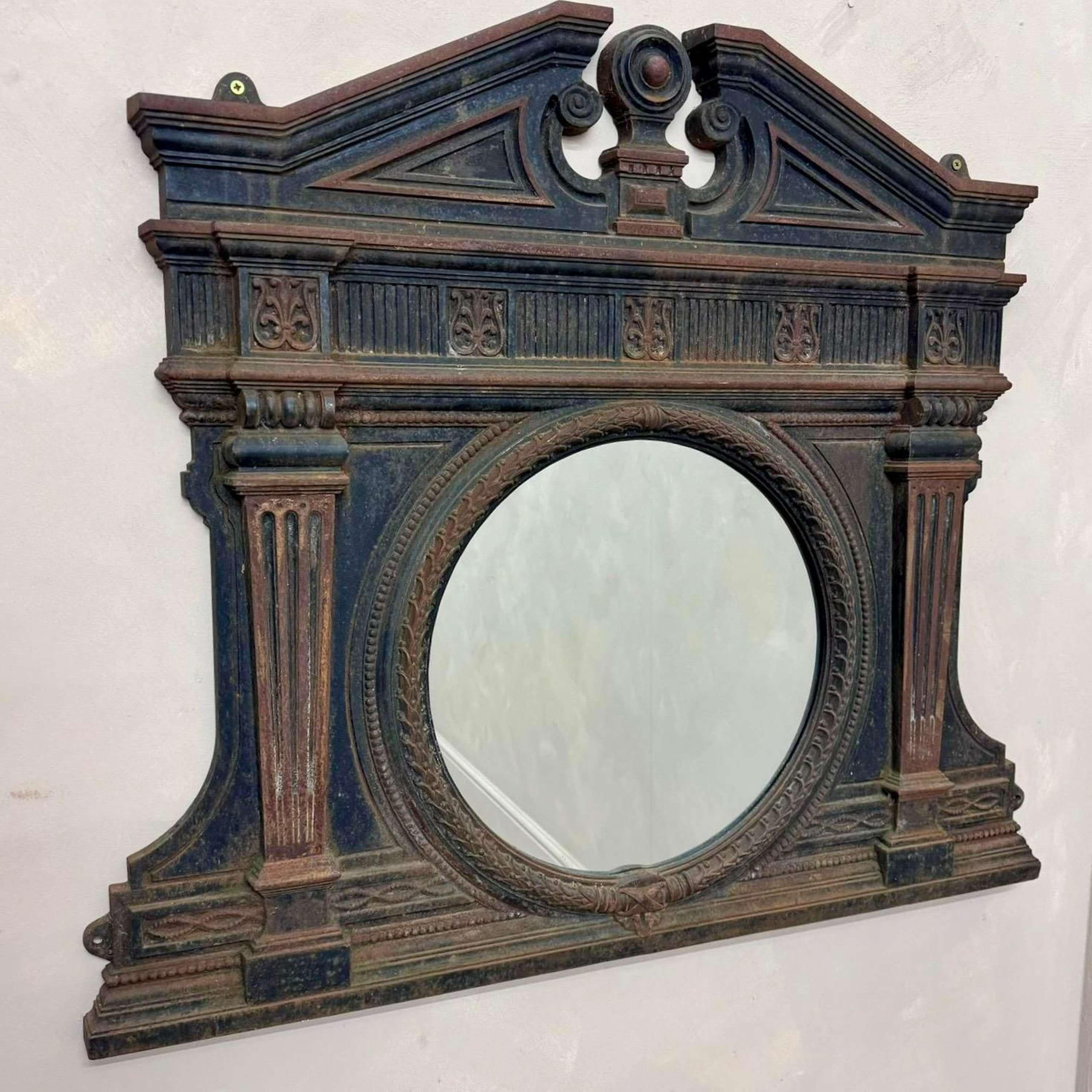 A Victorian, cast iron Over Mantle Mirror.
This would have been placed over/ built into a cast iron mantlepiece.
With decorative moulding, rope twist detail around the mirror with a shapely  pediment.
We have 2 of these which were removed from a 
