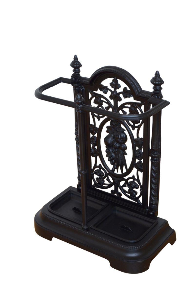 K0386 Attractive Victorian umbrella stand / walking stick stand in cast iron with intricate pierced floral and leaf design, umbrella holder and two removable drip trays. 
This antique hall stand is in home ready condition. c1880
H26 3/4