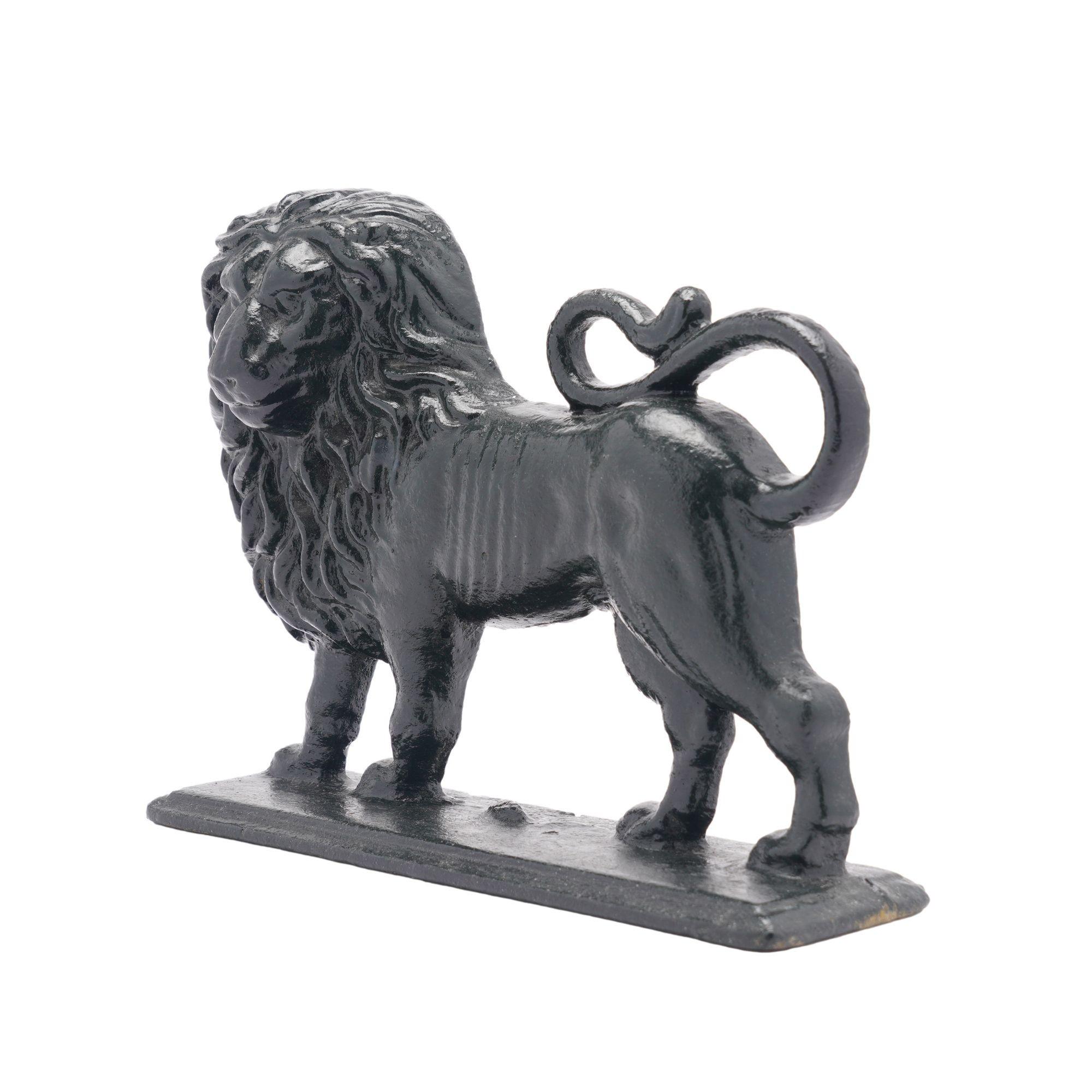 Painted English Victorian cast iron lion doorstop with hollow back. The lion features a full mane and curled tail and rests on a solid rectangular base.
England, circa 1850-1900.