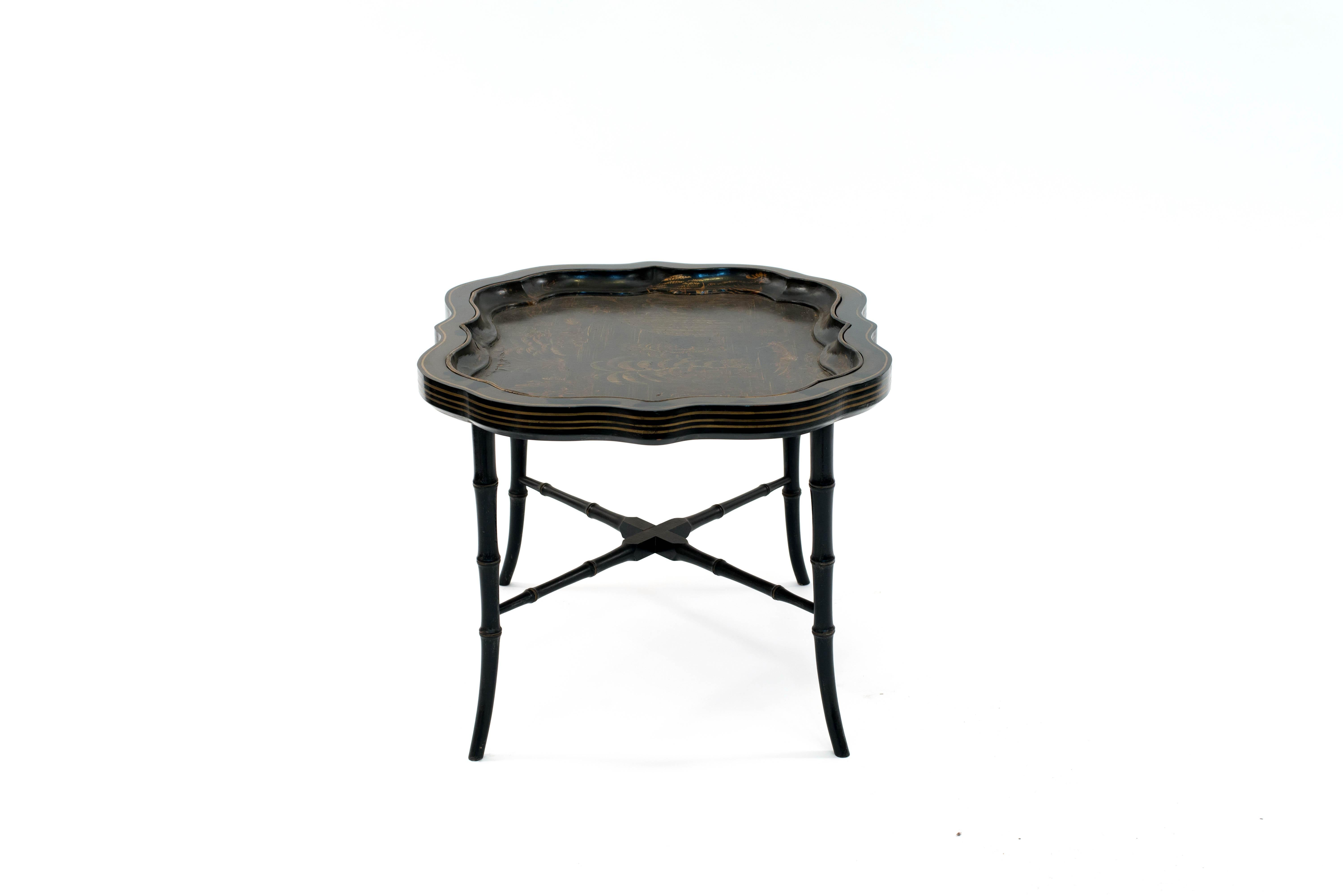 English Victorian black lacquer and gold chinoiserie decorated papier mache shaped tray top table with faux bamboo base.