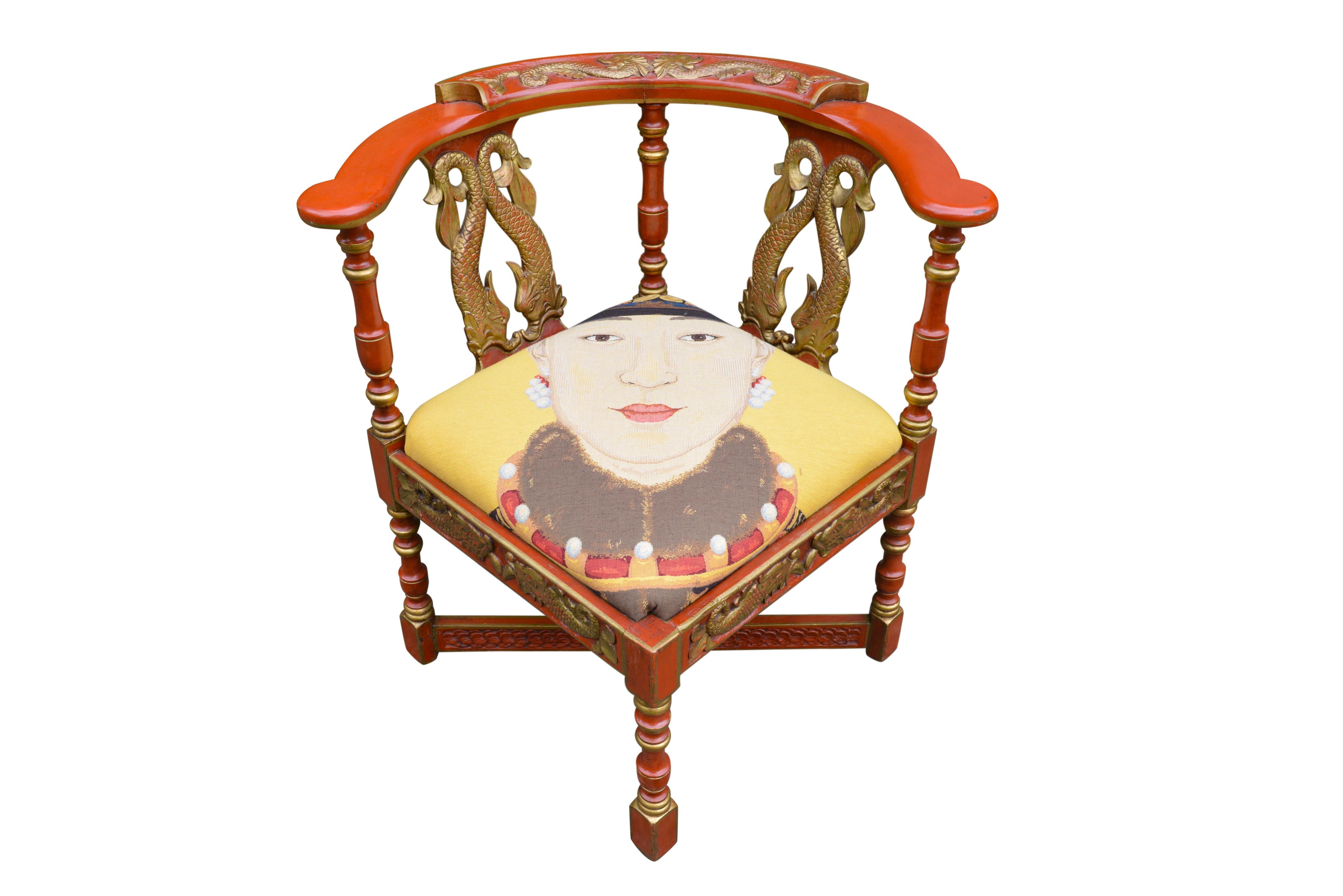 Unique red and gold painted English Victorian corner chair. Raised on baluster legs, with carved mythological sea monsters. Appealing colour and desirable aged patina. Reupholstered with piece of tapestry representing a Chinese emperor.