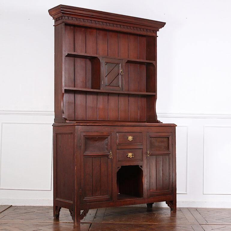 A charming Eastlake or Aesthetic Movement style dresser or buffet with a useful combination of drawers and cabinets and open shelving in the top. The piece retains its original faux-grain painted finish with a lovely aged surface and patina. Very